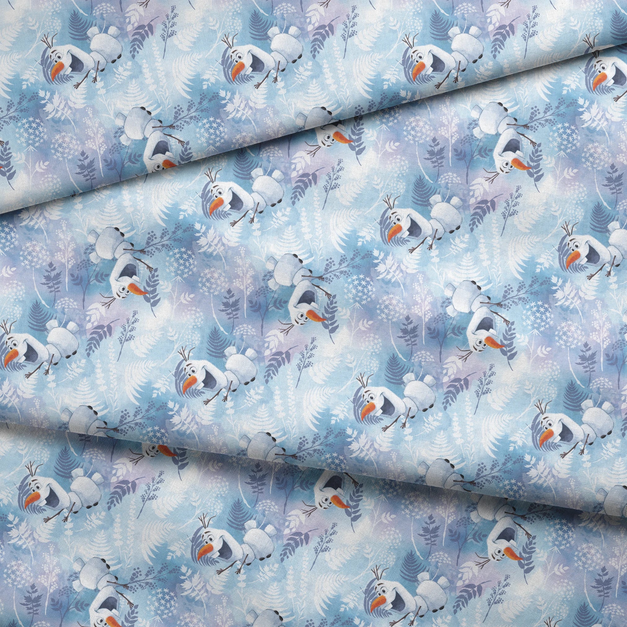 Cheerful Olaf playing among delicate ferns and snowflakes on a light blue background fabric fold mockup