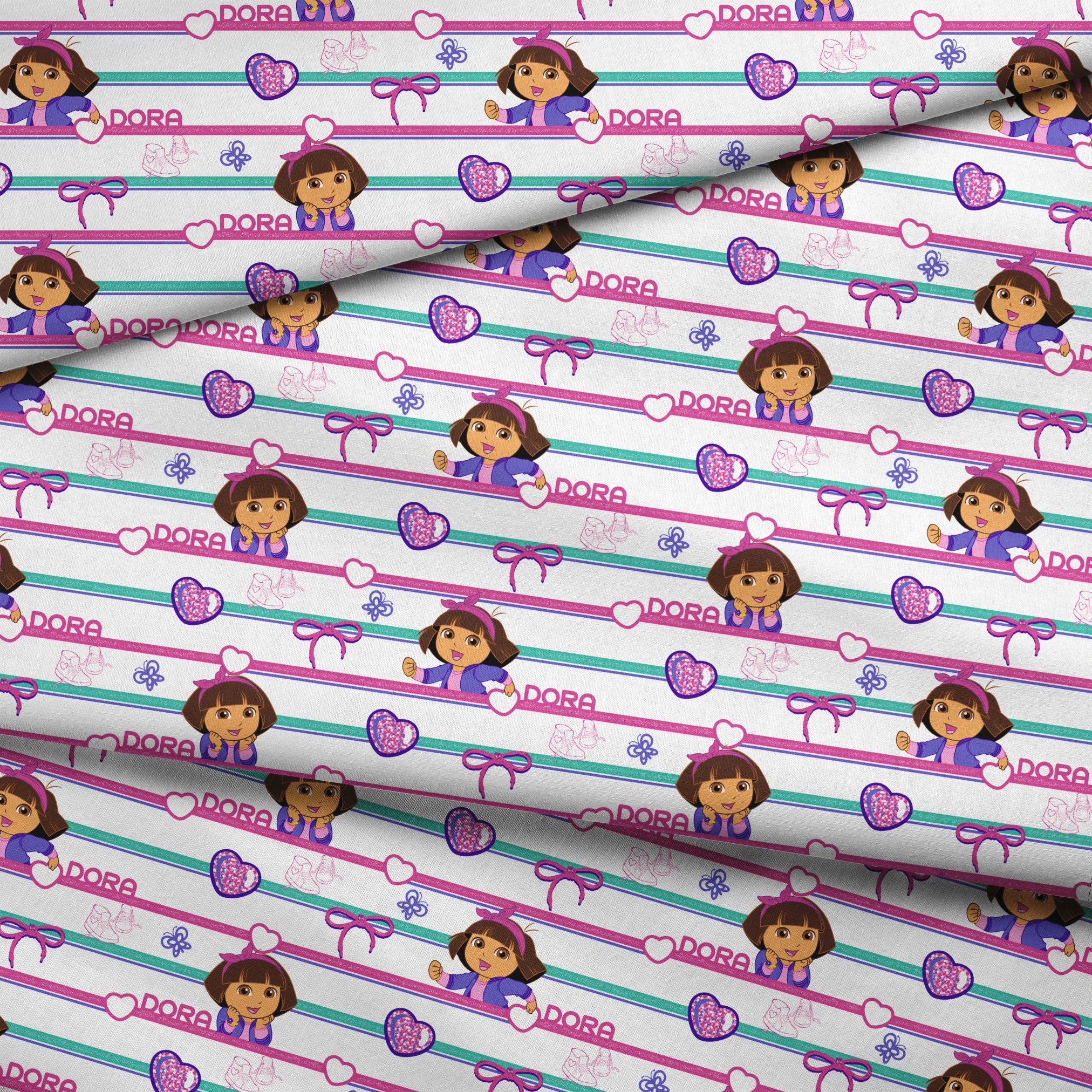 Colorful Dora the Explorer pattern with horizontal stripes featuring purple hearts, bows, butterflies, and "DORA" text on pink and green backgrounds fabric fold mockup