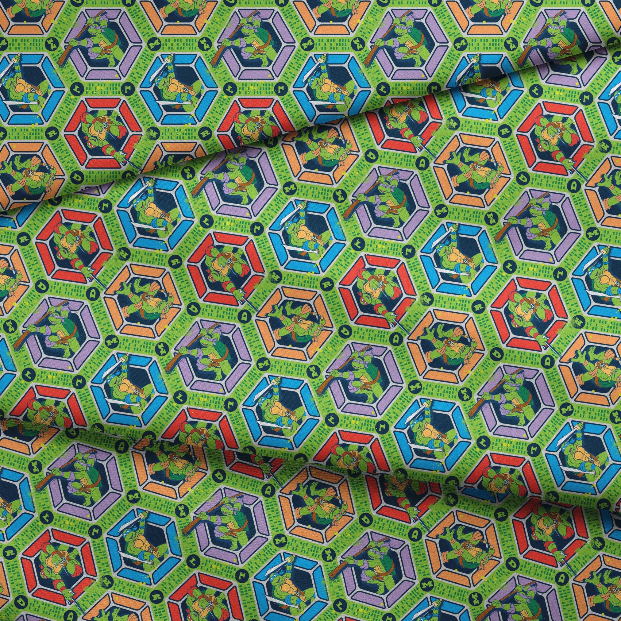Colorful hexagonal pattern featuring the Teenage Mutant Ninja Turtles in action poses on green backgrounds with digital text elements fabric fold mockup