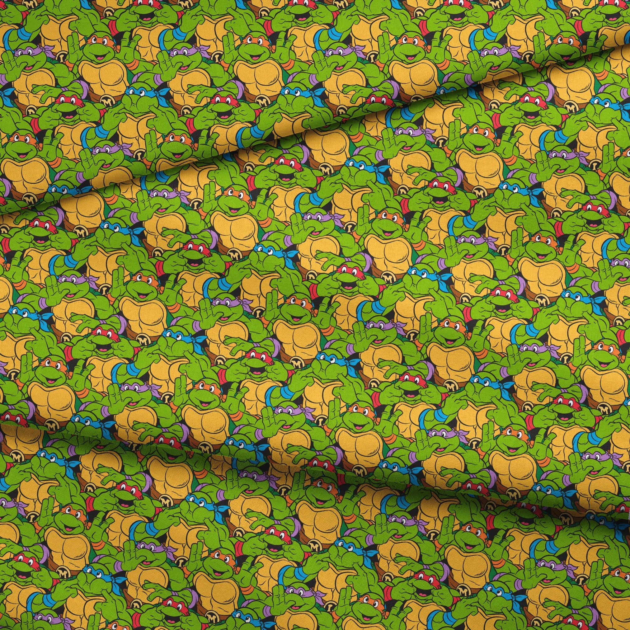 Colorful pattern of cartoon Teenage Mutant Ninja Turtles with green skin and yellow shells fabric fold mockup