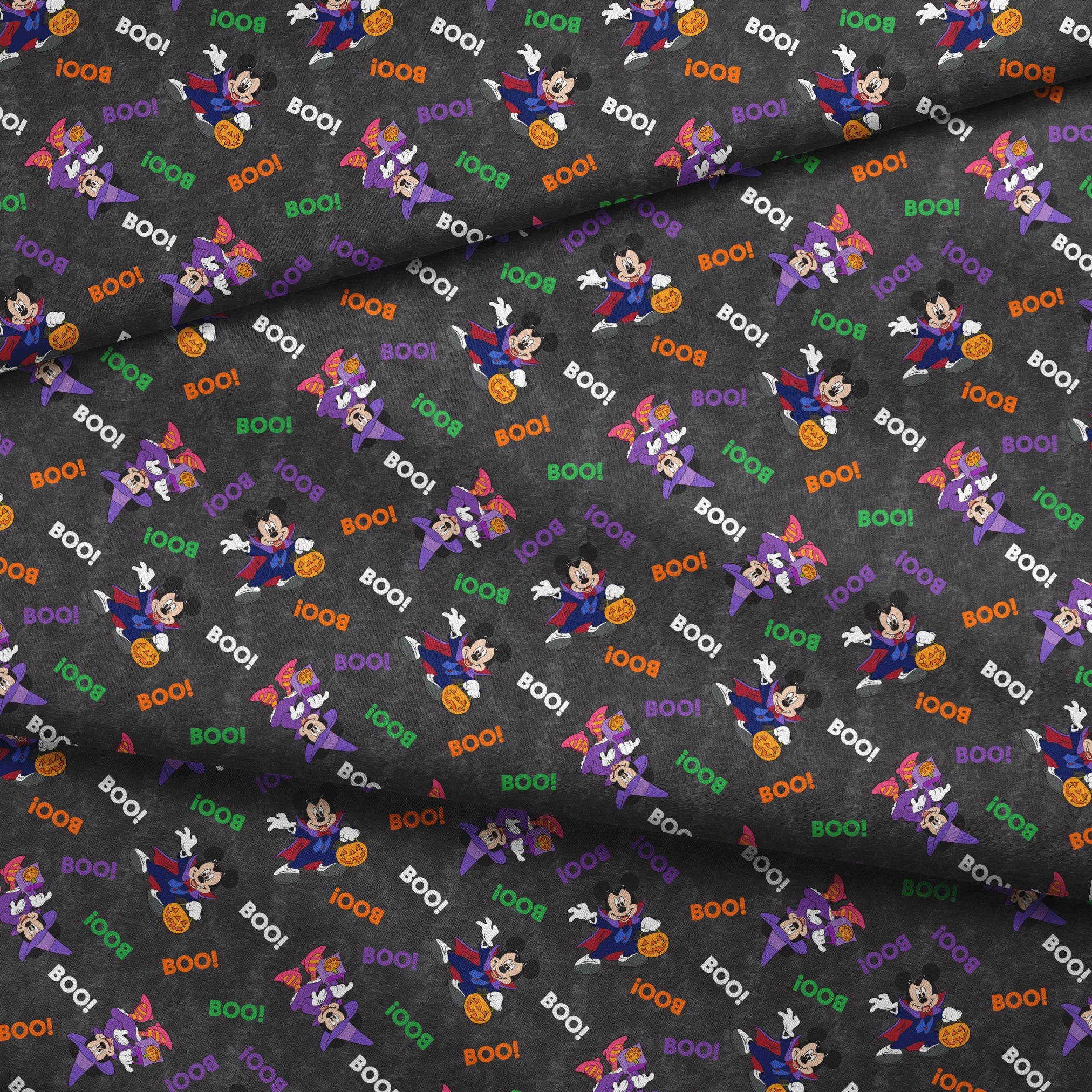 Halloween themed pattern with Disney characters in costumes, pumpkins, and colorful "BOO!" text on dark gray background. fabric fold mockup