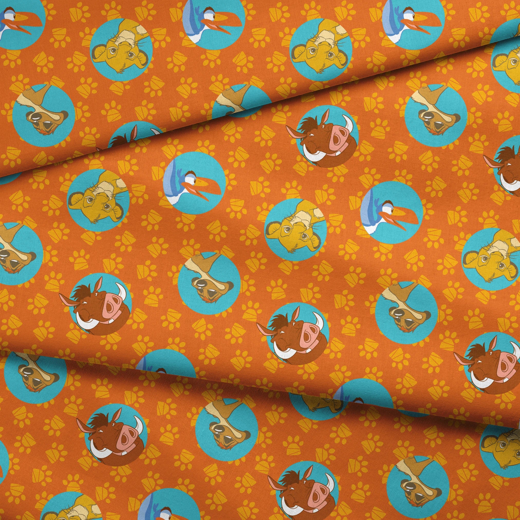 Cartoon animal characters in blue circles on orange background with yellow paw prints pattern fabric fold mockup