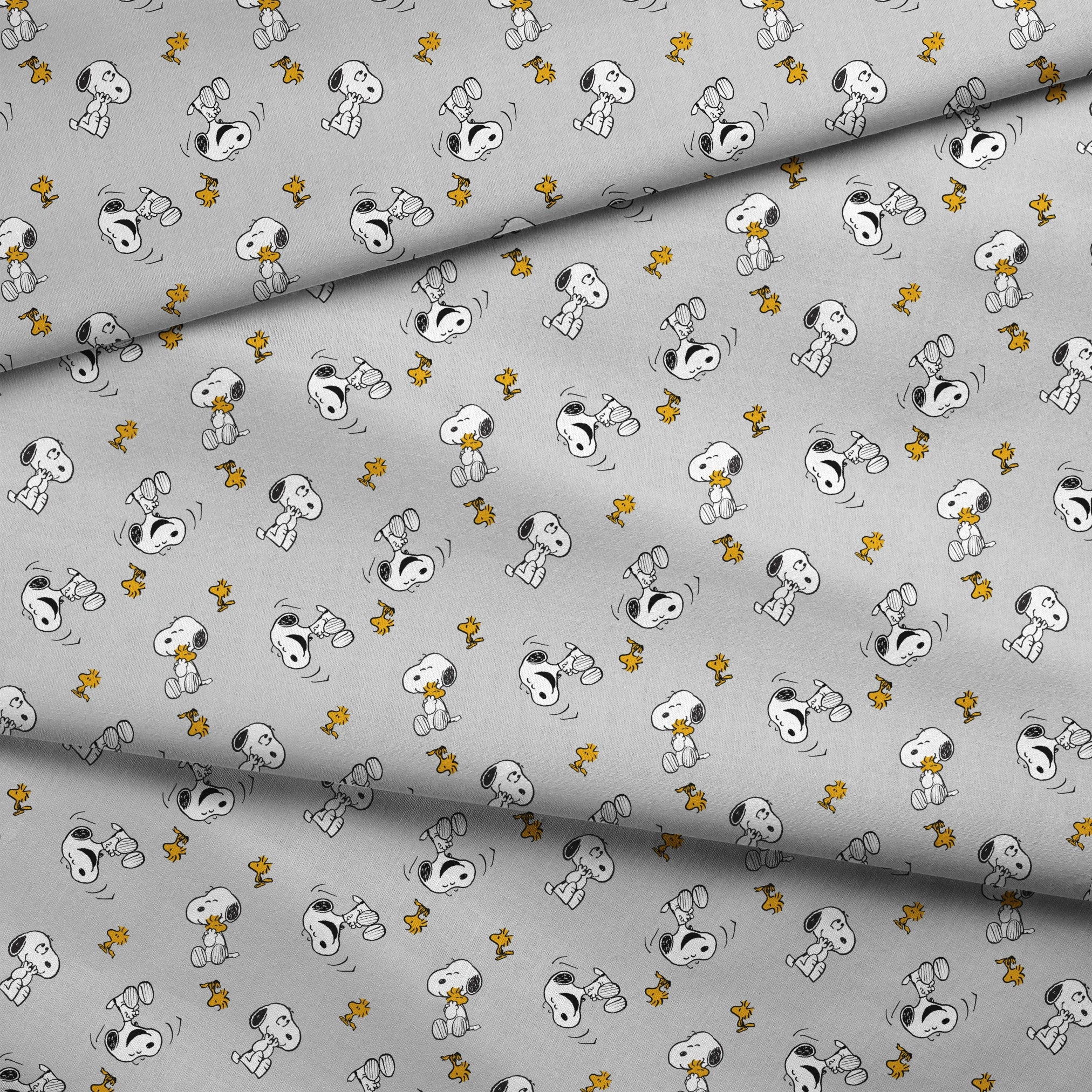 Pattern of Peanut's Snoopy and Woodstock on light gray background fabric fold mockup