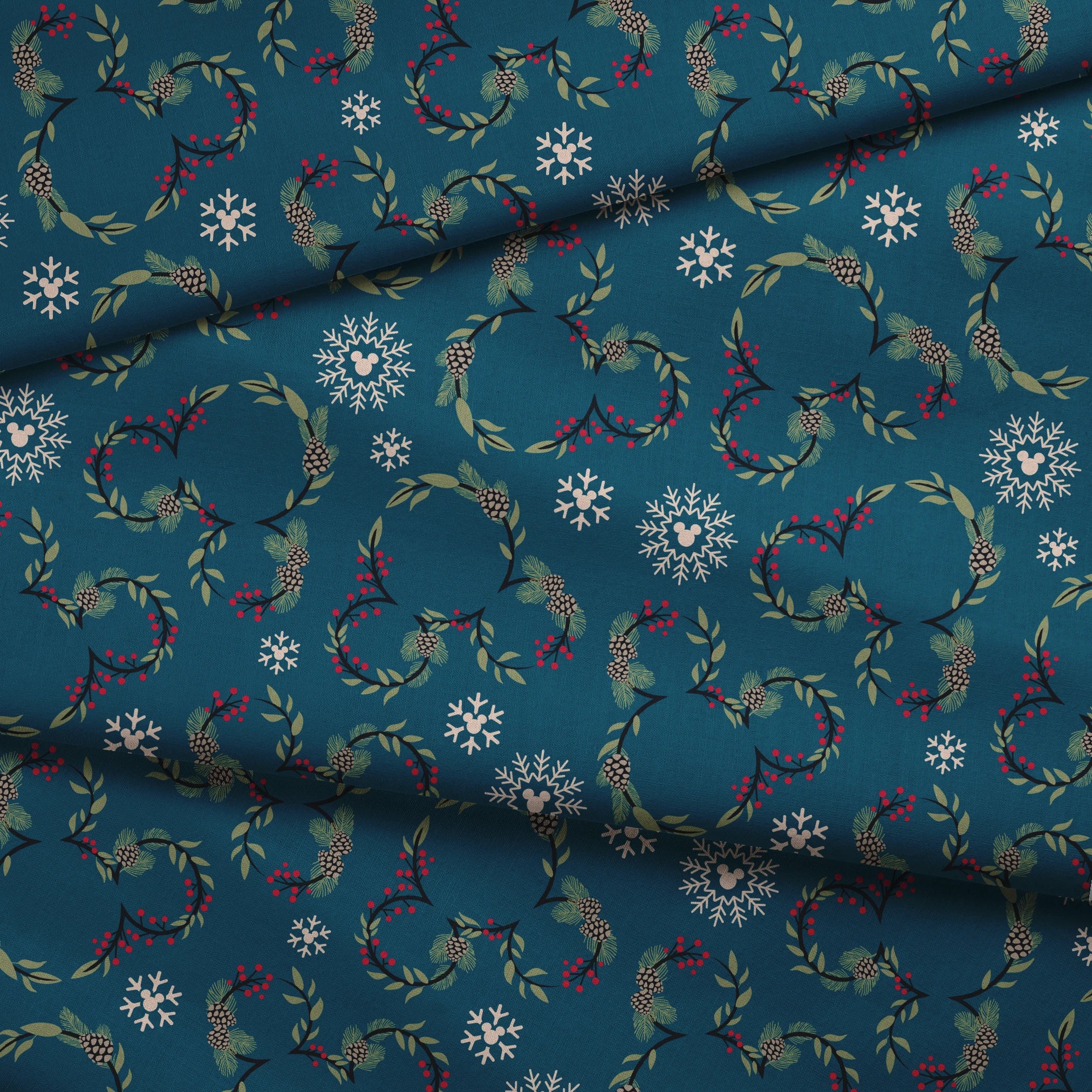 Holiday pattern with circular wreaths, white snowflakes, and botanical elements on teal background fabric fold mockup