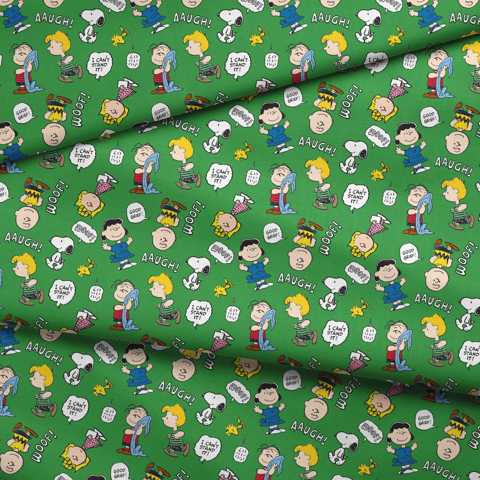 Peanuts comic characters on green background - Snoopy, Woodstock, and gang with speech bubbles like "AAUGH!" and "I CAN'T STAND IT! fabric fold mockup