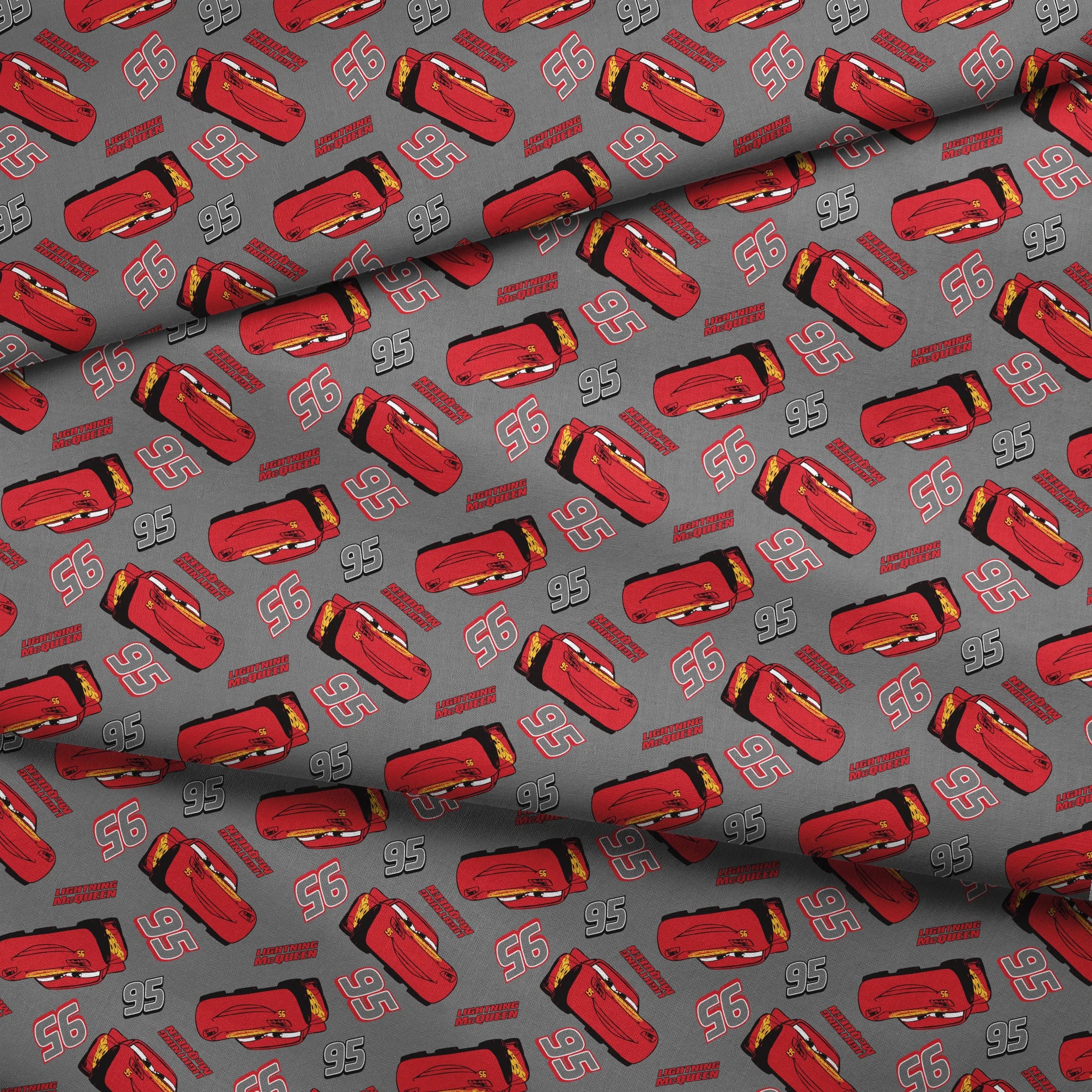 Lightning McQueen pattern with red race cars and number 95 on gray background fabric fold mockup