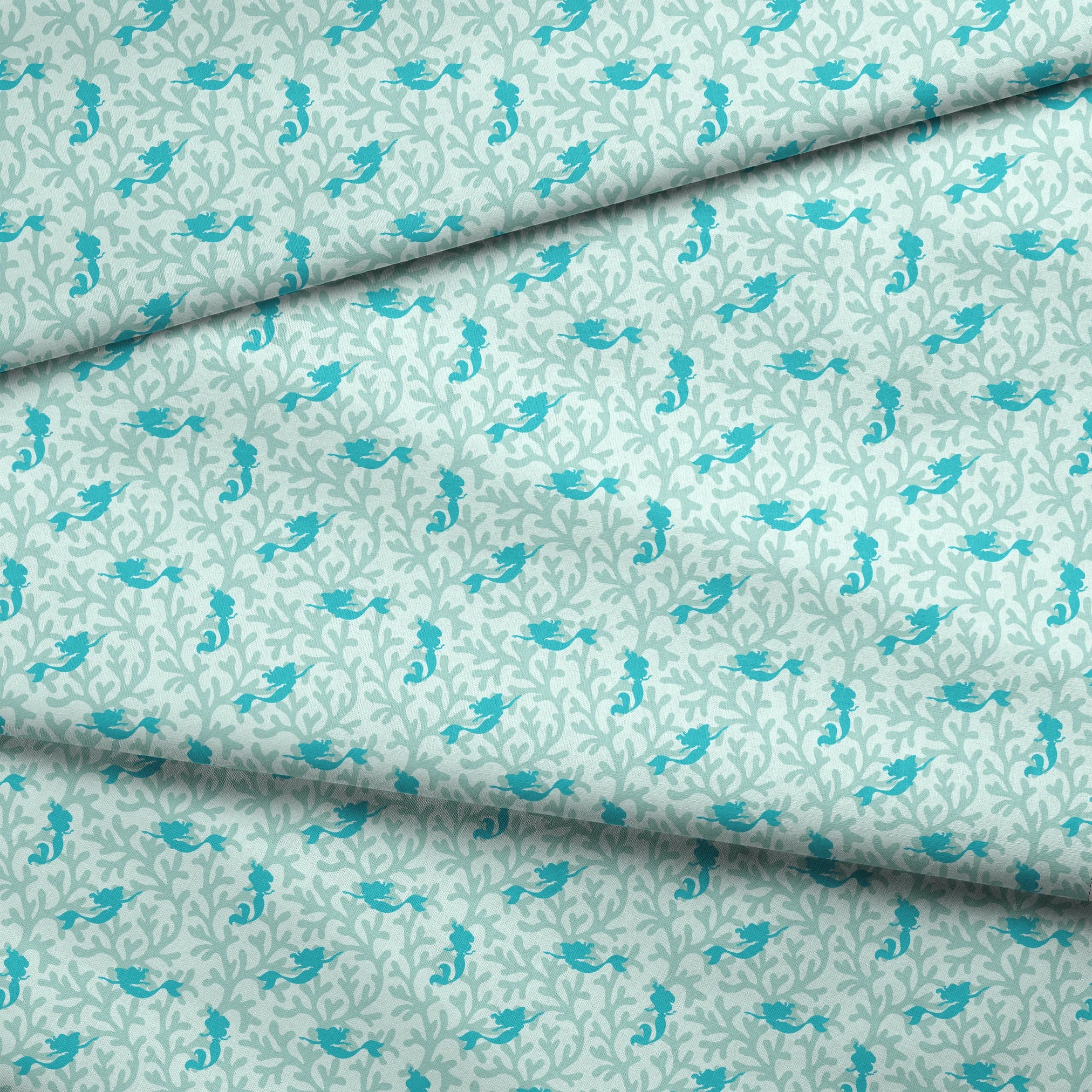 Abstract pattern with light mint green coral shapes and The Little Mermaid silhouettes fabric fold mockup