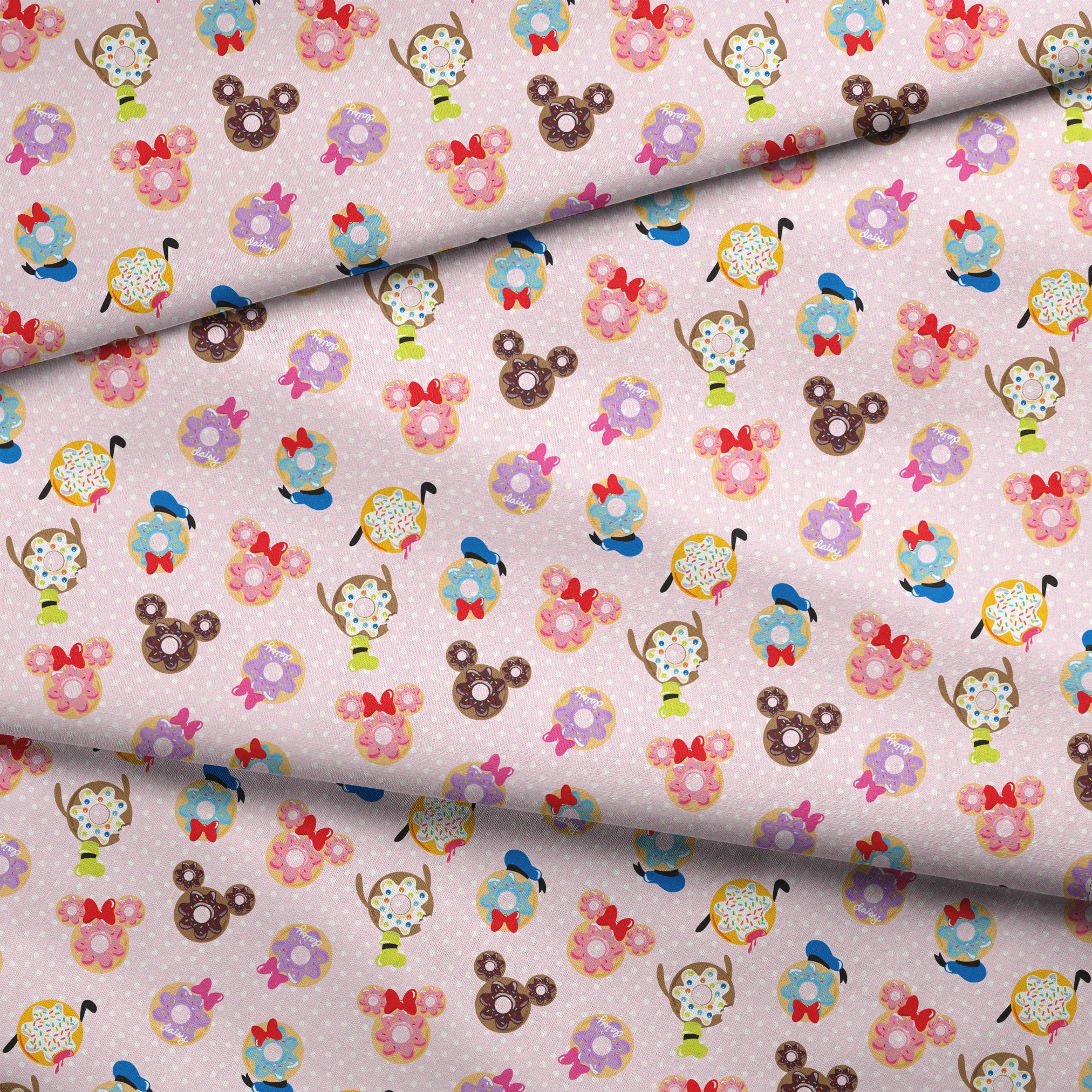 Mickey Mouse & friends donuts in various shapes on a pink polka dot background. fabric fold mockup