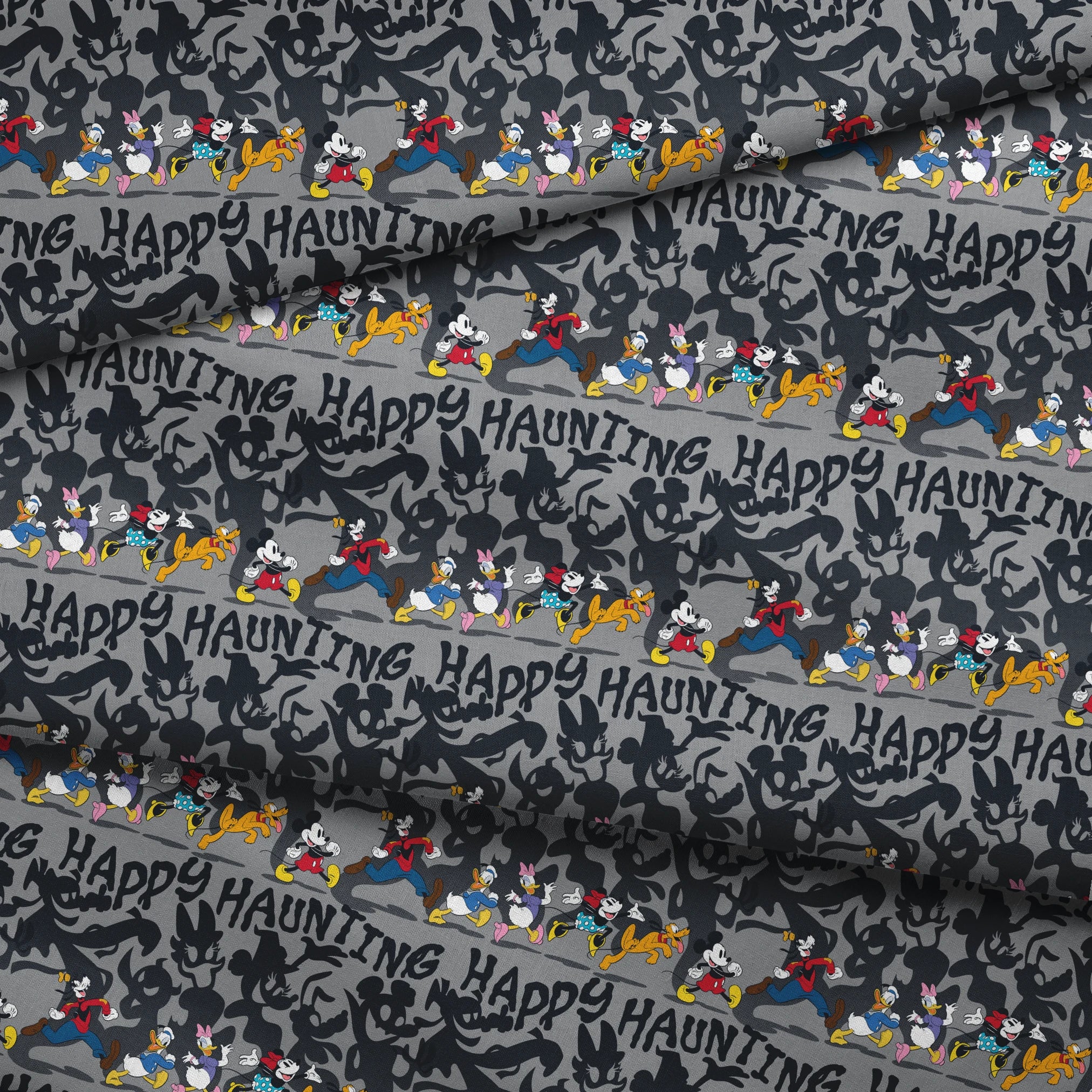 Classic Disney characters on dark gray background with "Happy Haunting" text, Mickey, Donald, and friends in Halloween-themed poses. fabric fold mockup