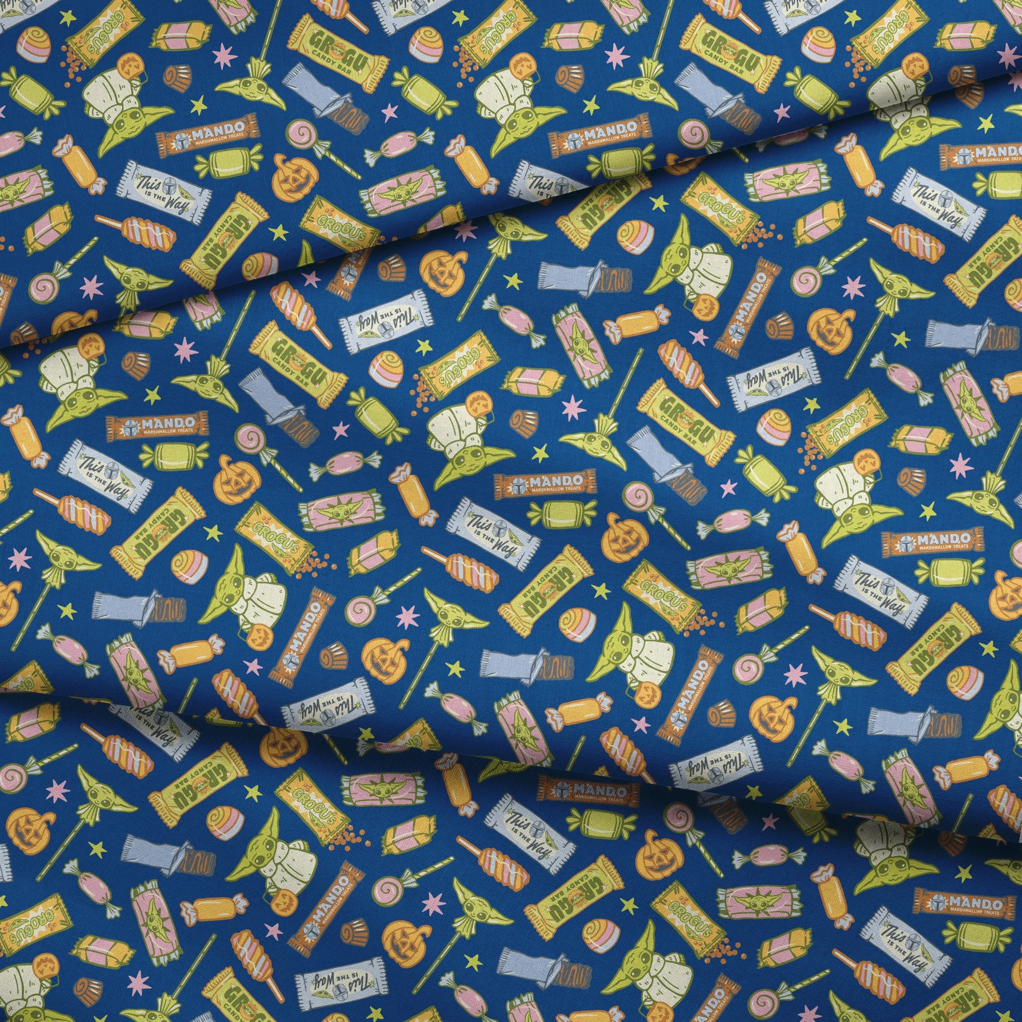 Colorful candy pattern with wrapped sweets, lollipops, and treats on dark blue background fabric fold mockup