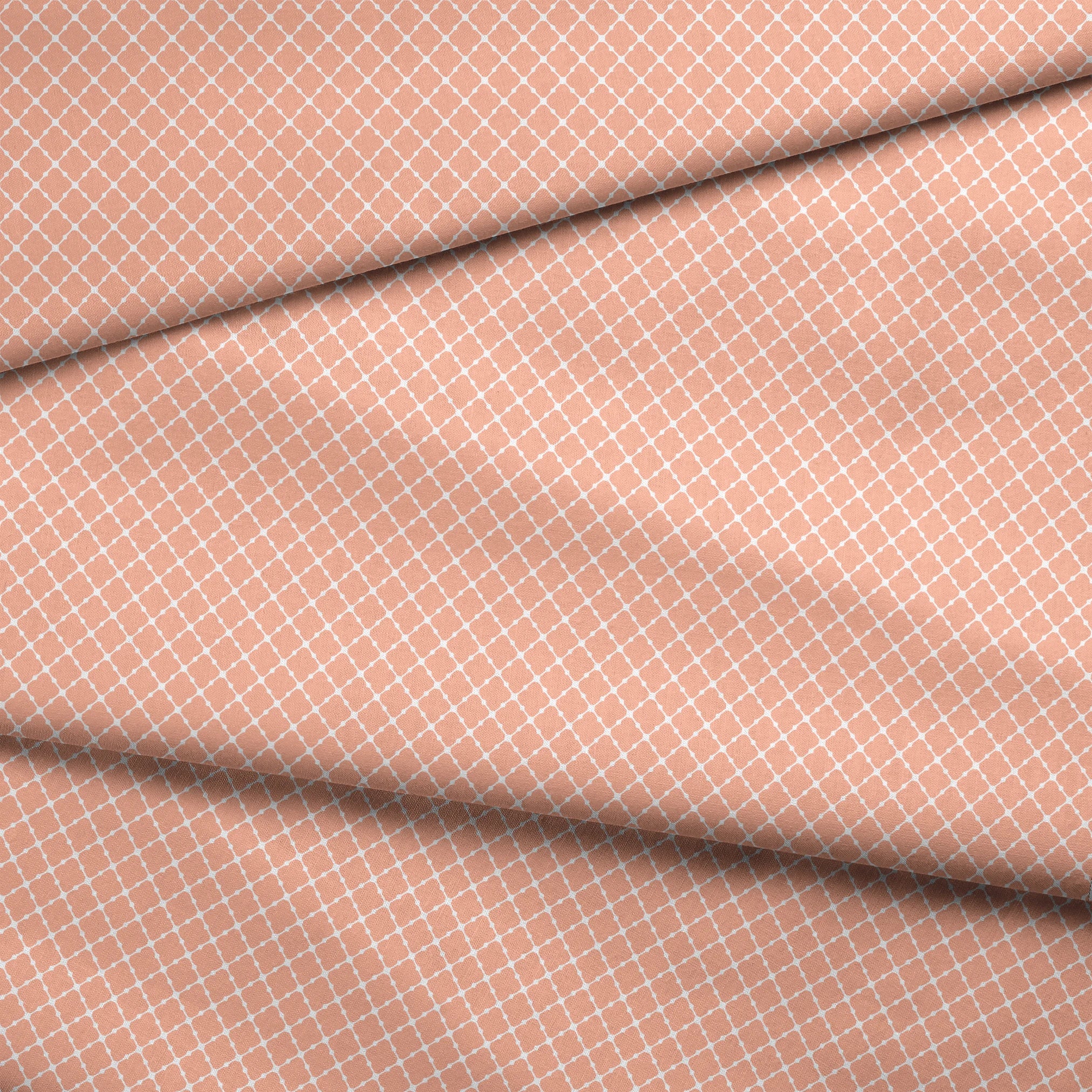 Peach and white quatrefoil pattern with regular geometric shapes in a lattice arrangement fabric fold mockup