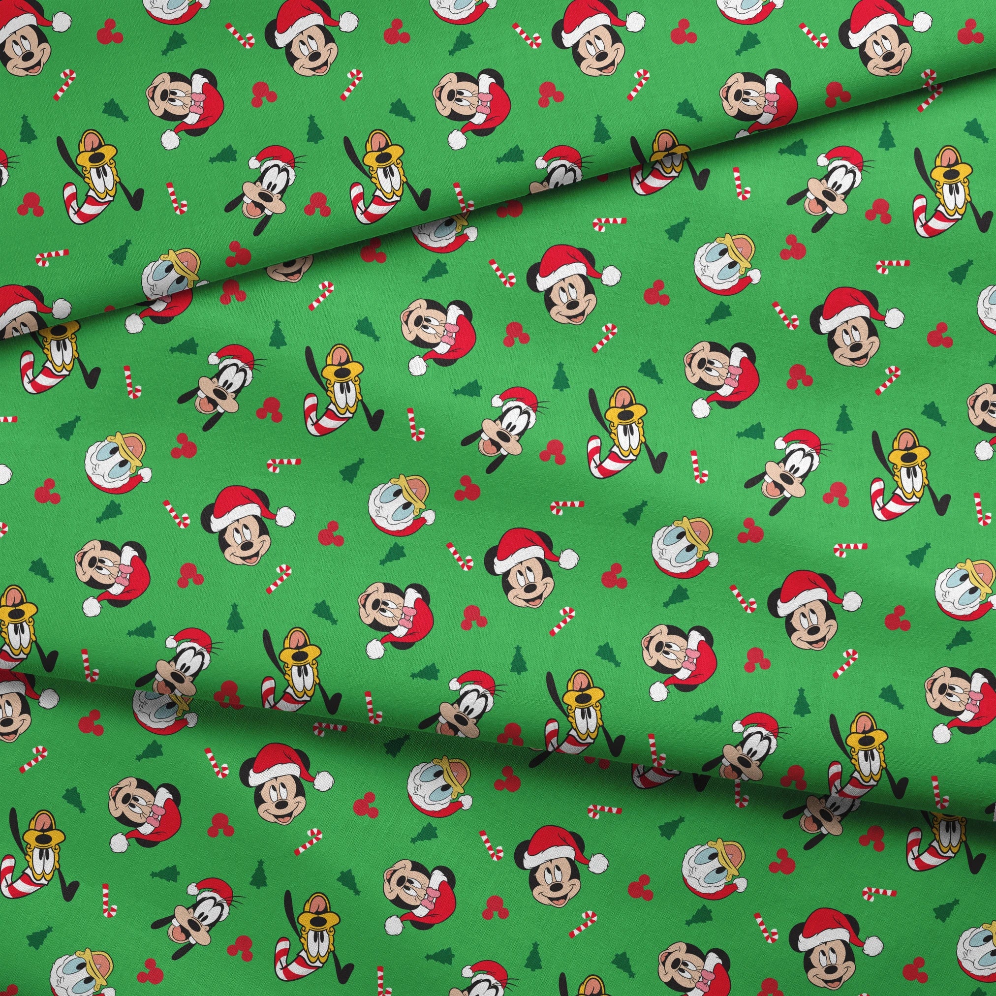 Disney Mickey Mouse characters in Santa hats on green background with candy canes and Christmas trees fabric fold mockup
