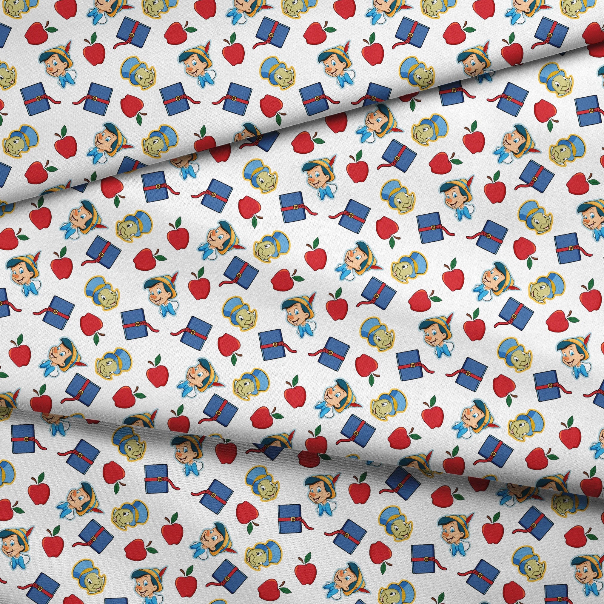 Pattern with cartoon character in pointed hat with blue bow, red apples, blue books with red straps, and yellow circular elements on white background fabric fold mockup