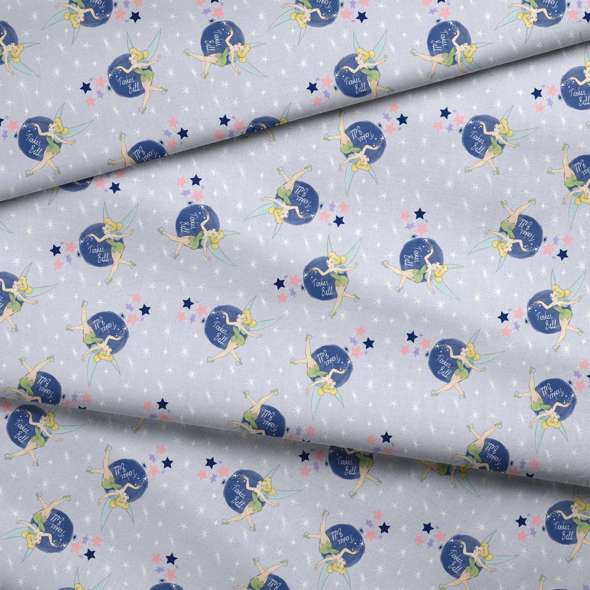 Tinker Bell pattern with the iconic fairy flying around blue moons and stars on a light gray background fabric fold mockup