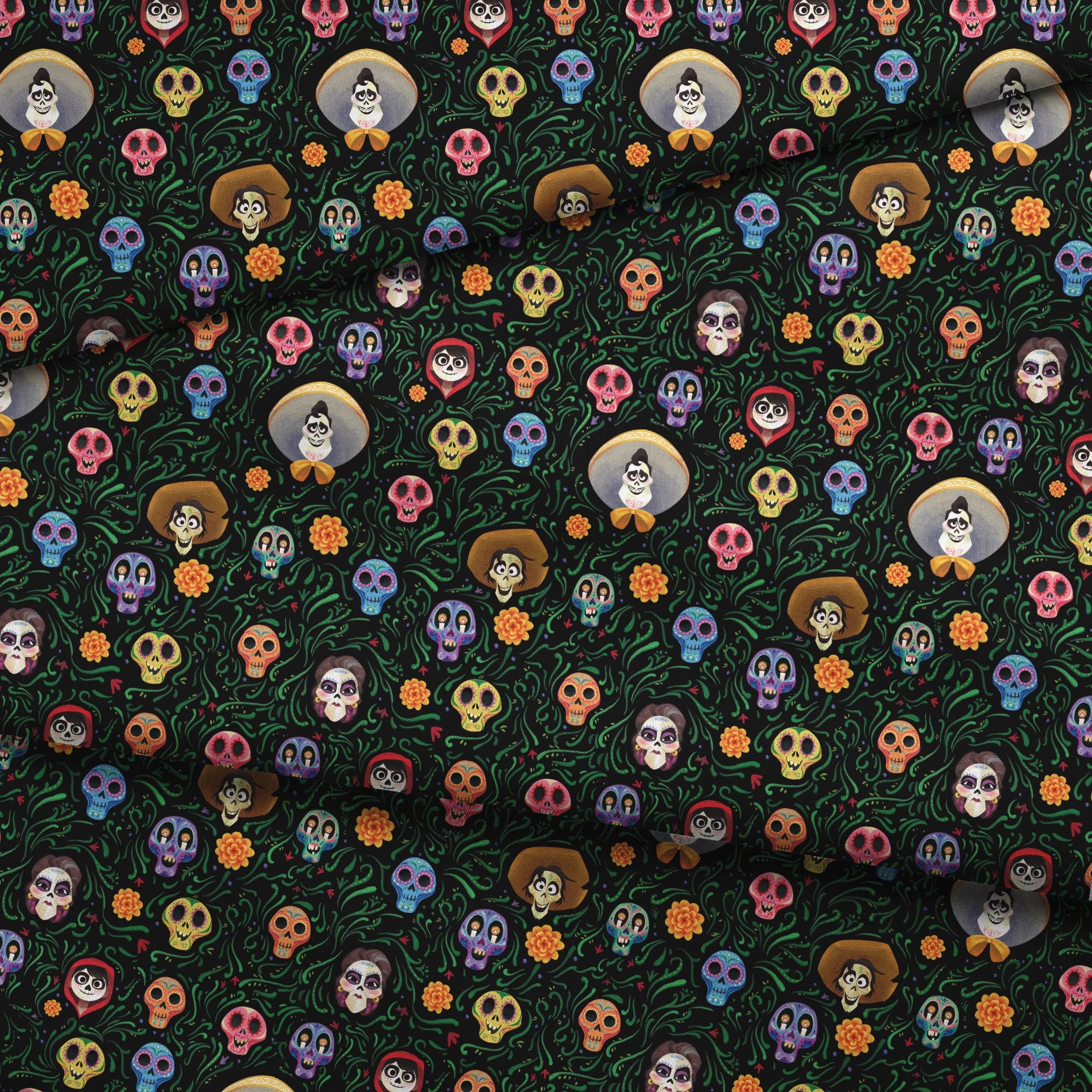 Colorful Coco stylized sugar skulls with sombreros scattered among green vines and orange flowers on black background fabric fold mockup