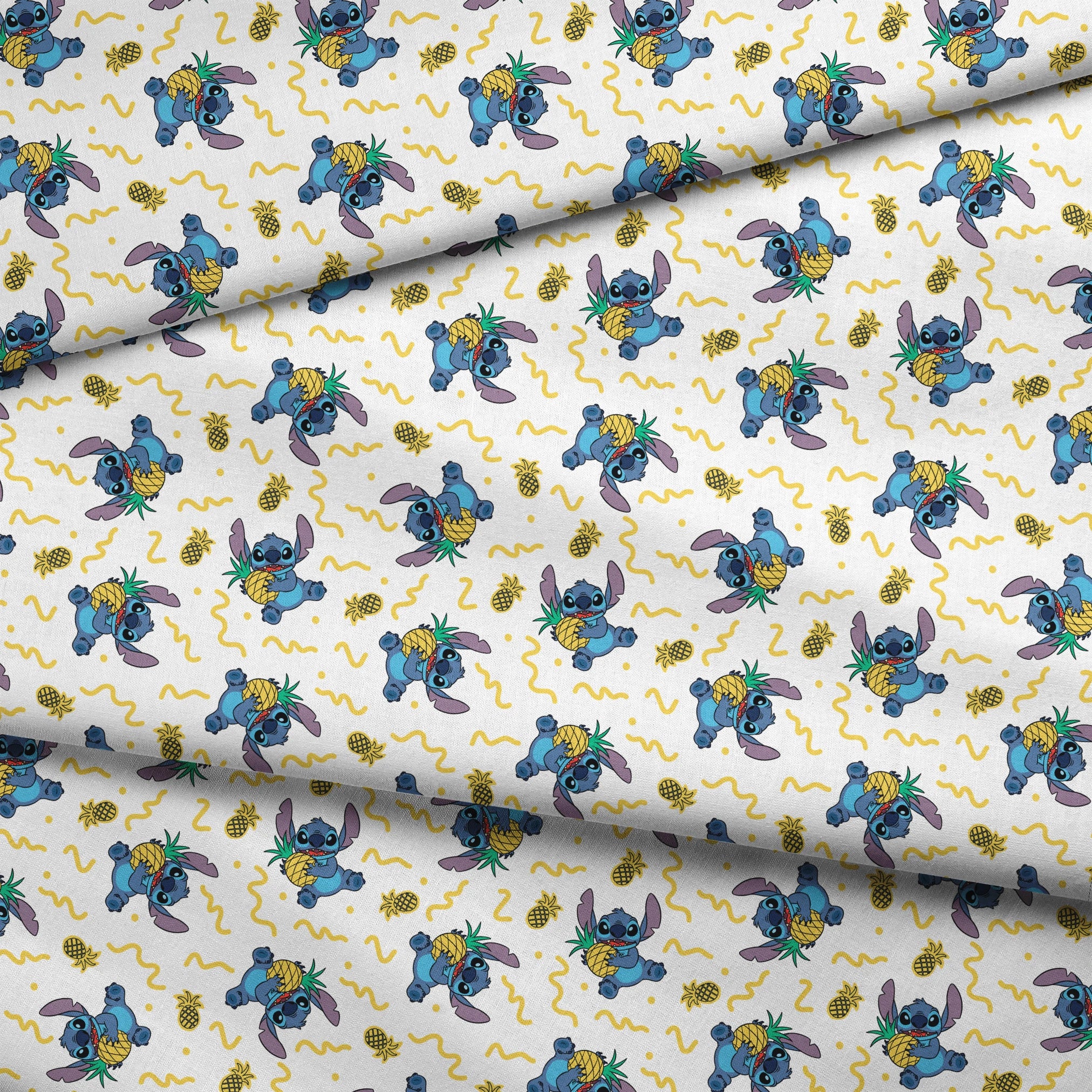 Disney's Stitch holding pineapples with yellow squiggly lines on white background pattern fabric fold mockup
