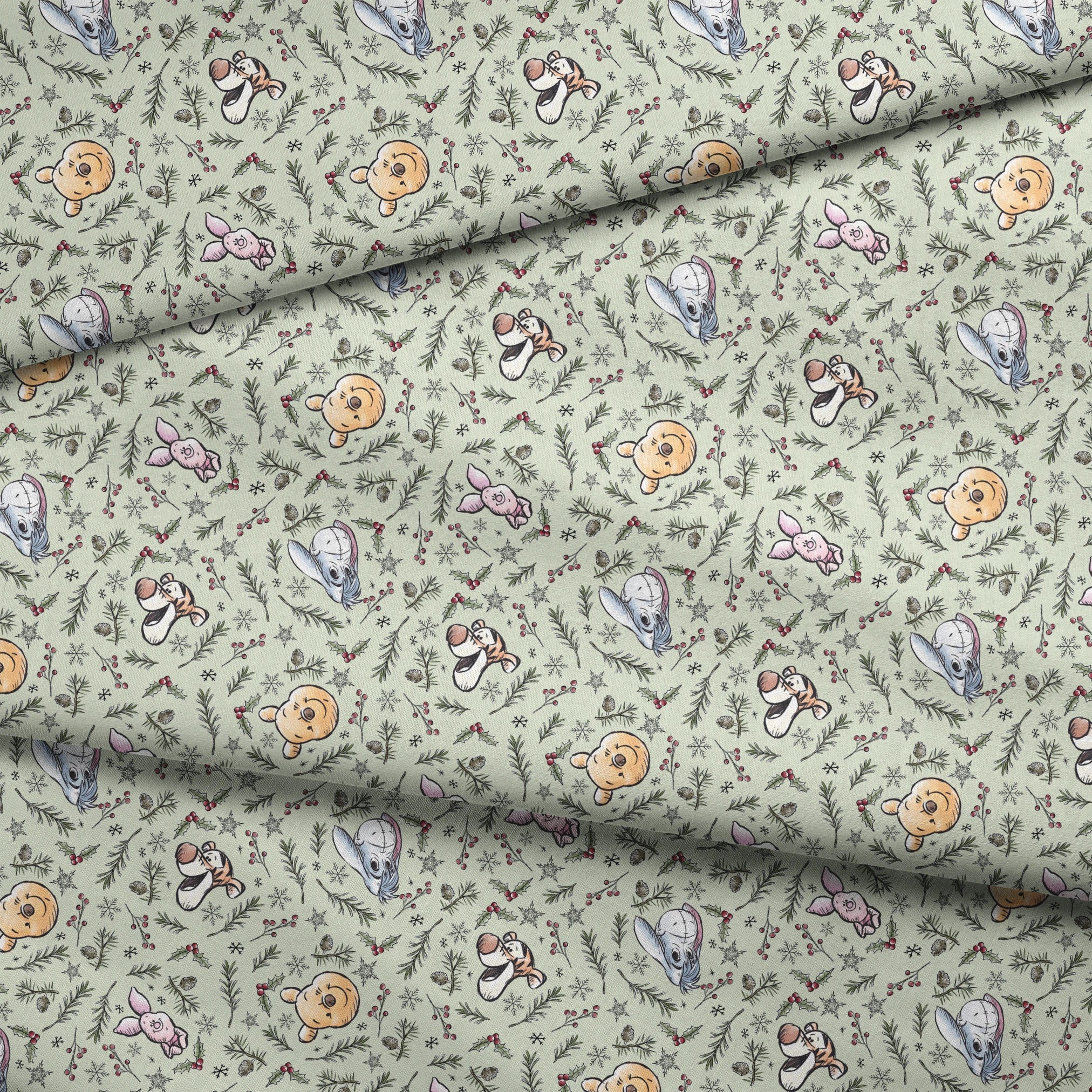 Whimsical holiday pattern with cartoon animals, pine branches, berries, and snowflakes on mint green fabric fold mockup
