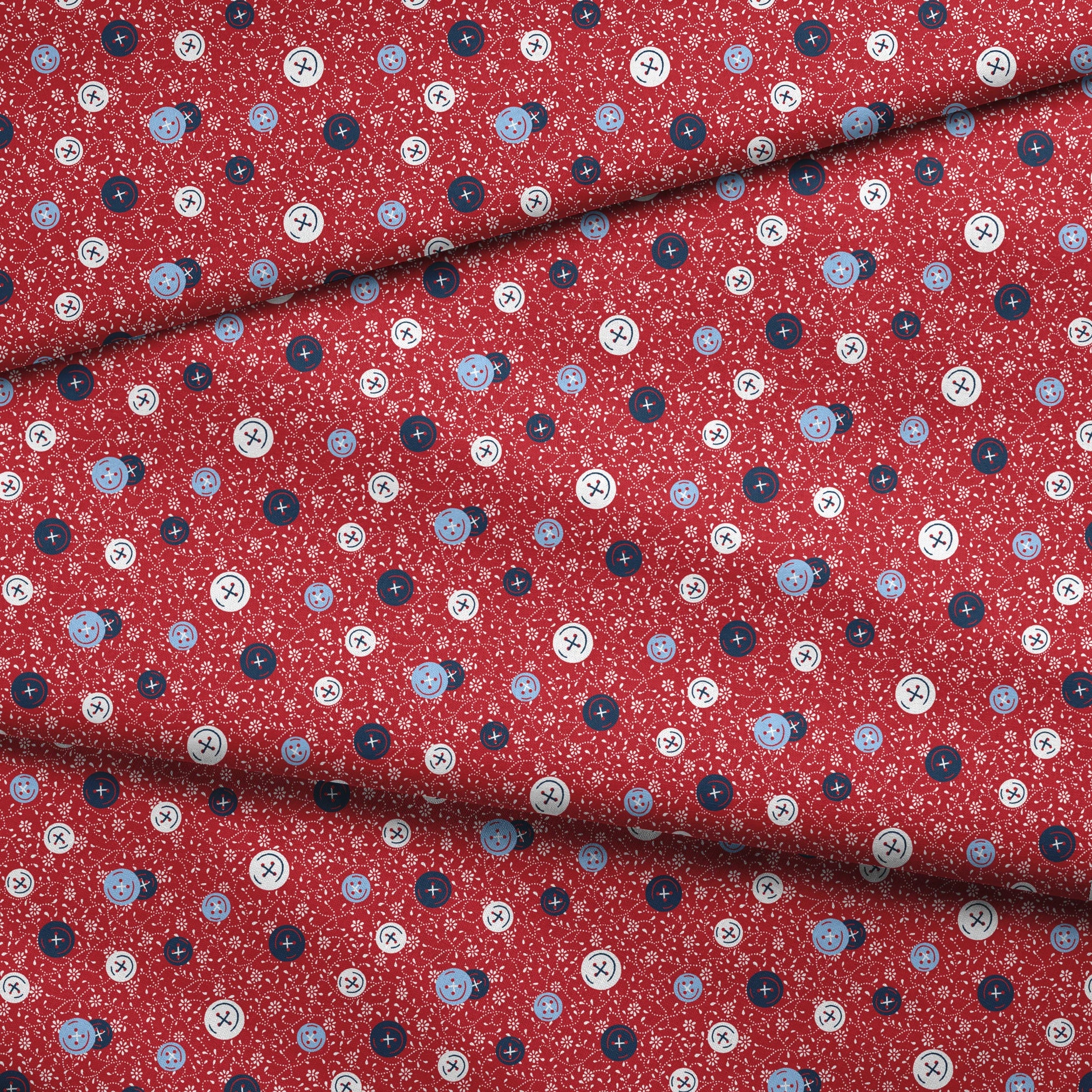 Red background with small white floral pattern featuring scattered button designs in blue, white, and navy cross details fabric fold mockup