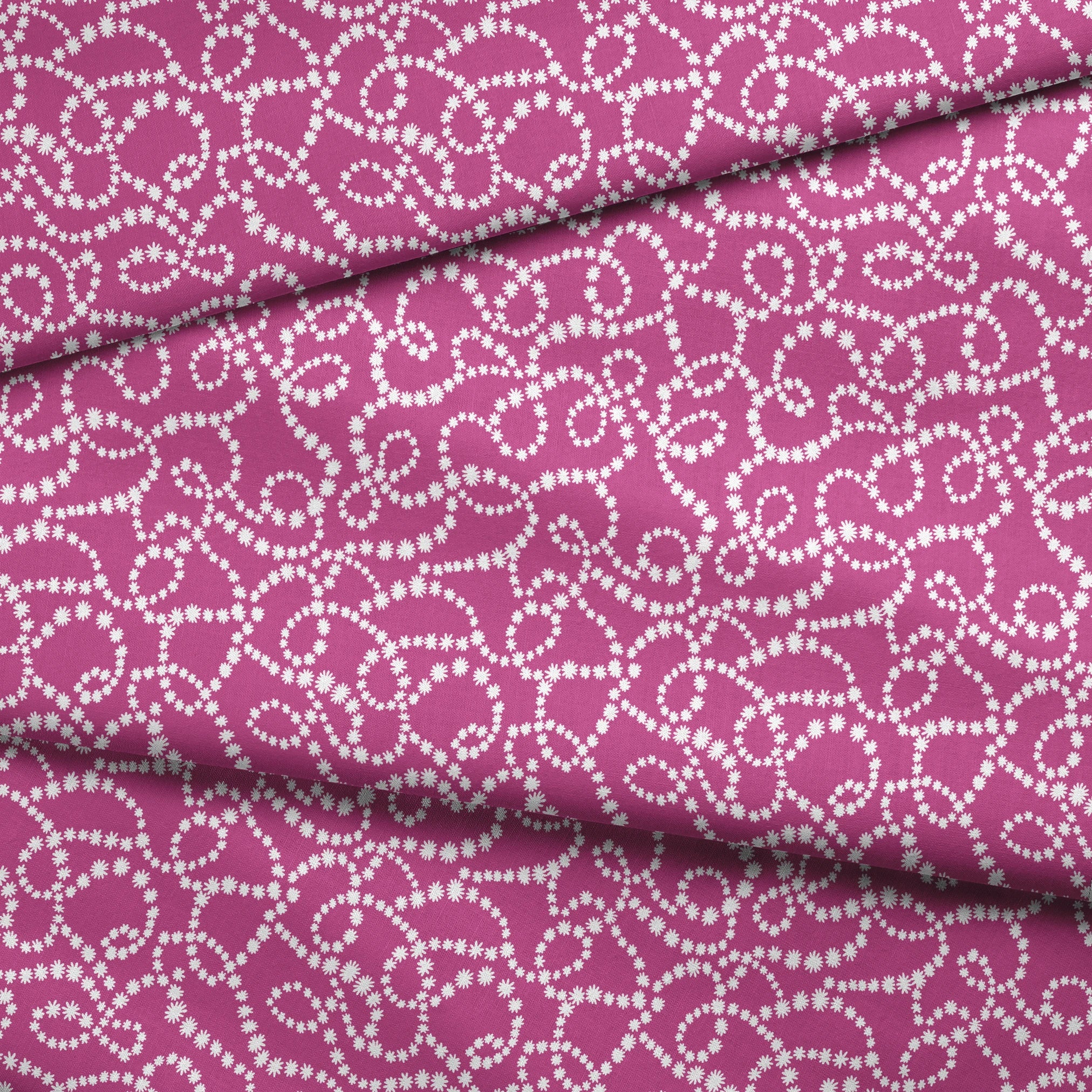 Magenta background with swirling white dotted pattern resembling pearl strands in decorative loops fabric fold mockup