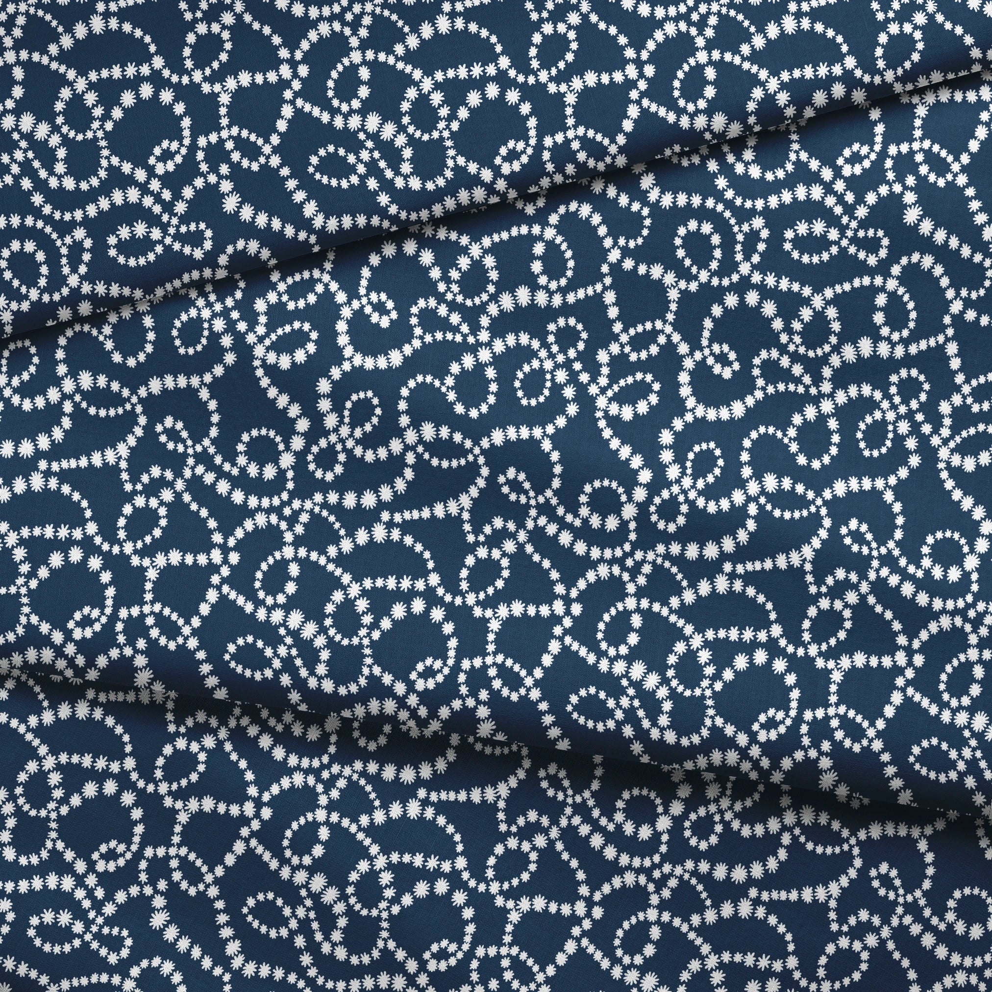 Navy blue background with swirling white dotted patterns creating circular and flowing designs fabric fold mockup