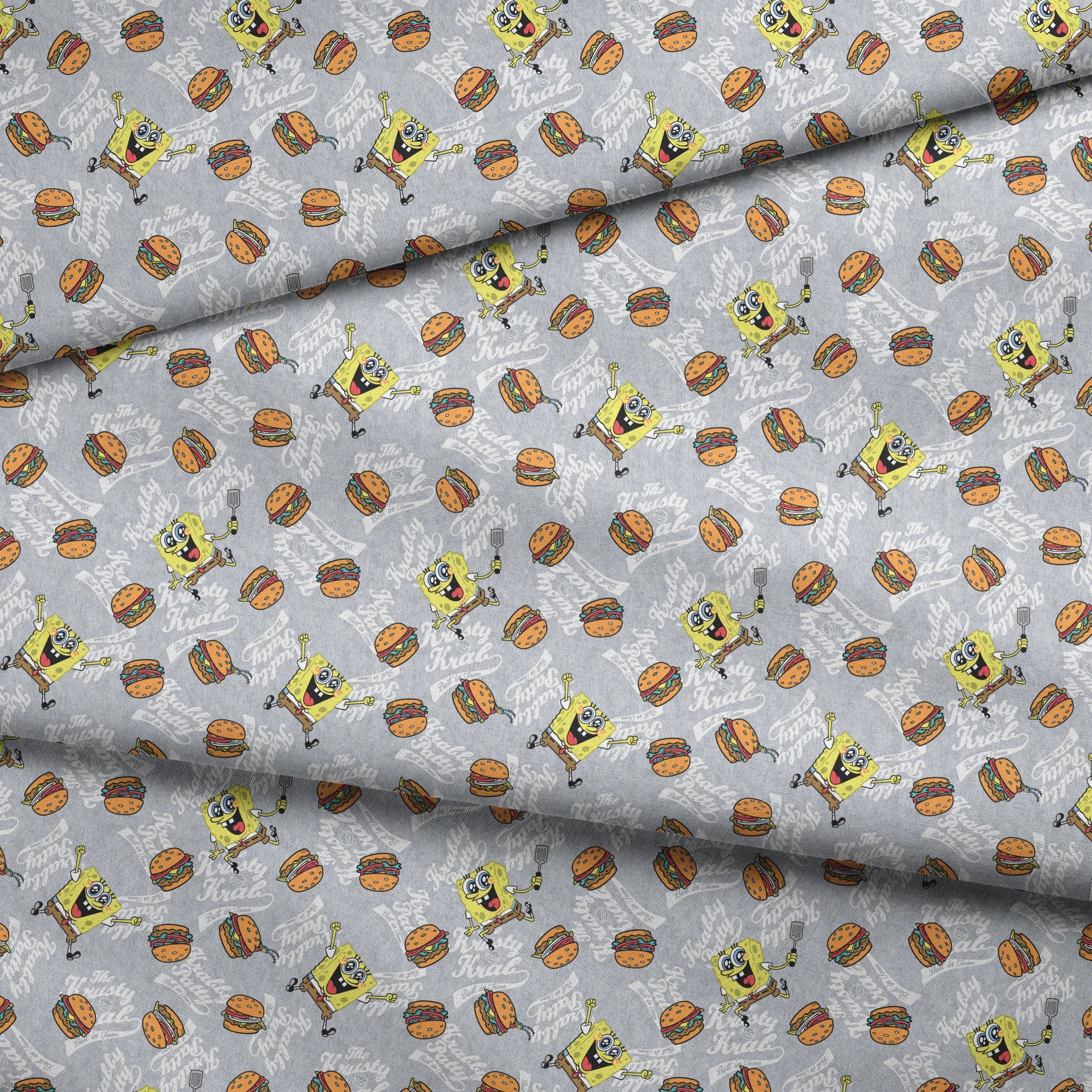 SpongeBob surrounded by Krabby Patties, spatulas, and “The Krusty Krab” text on a heather gray background in a playful cartoon-style design. fabric fold mockup