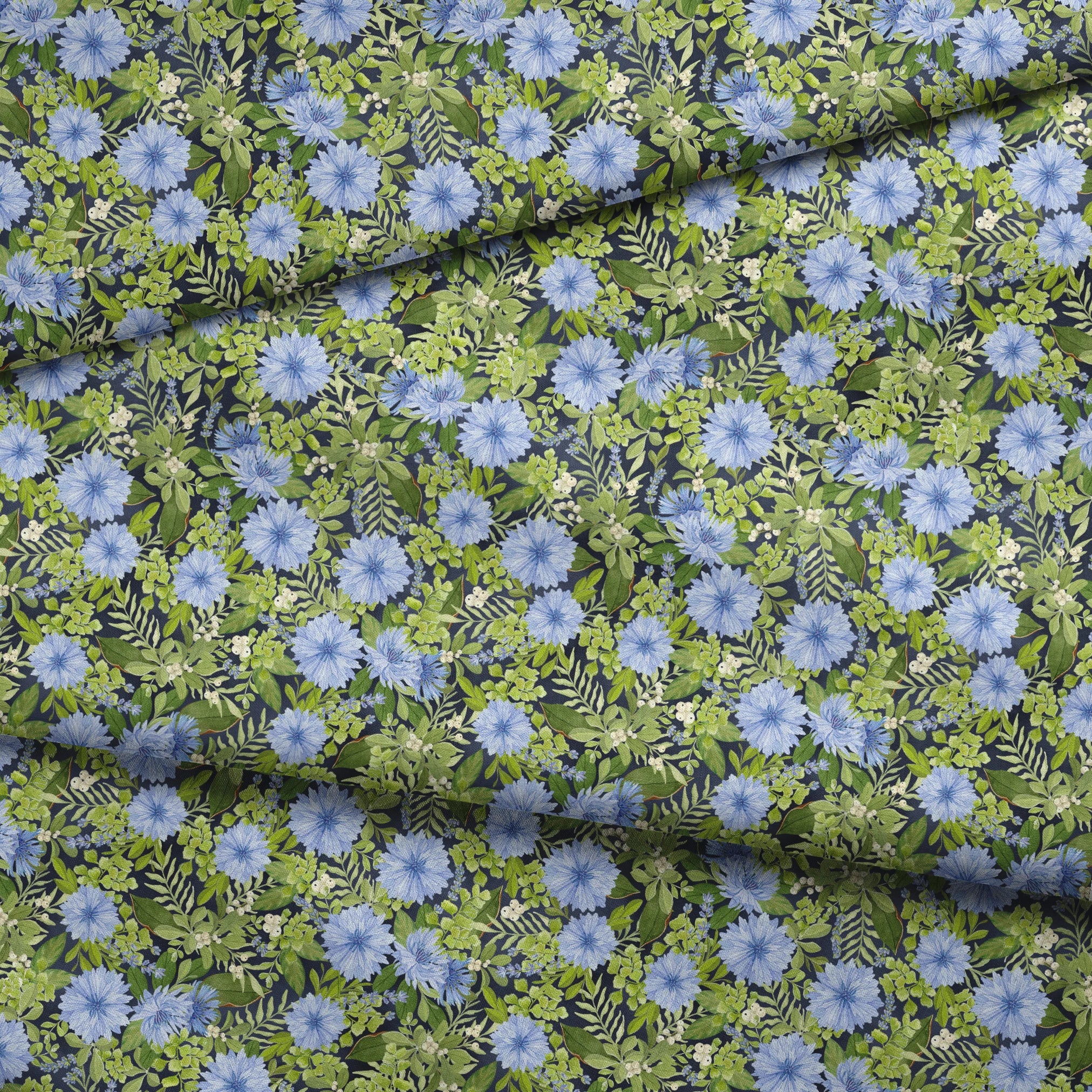 Beautiful floral pattern with light blue cornflowers and vibrant green leaves and foliage fabric fold mockup