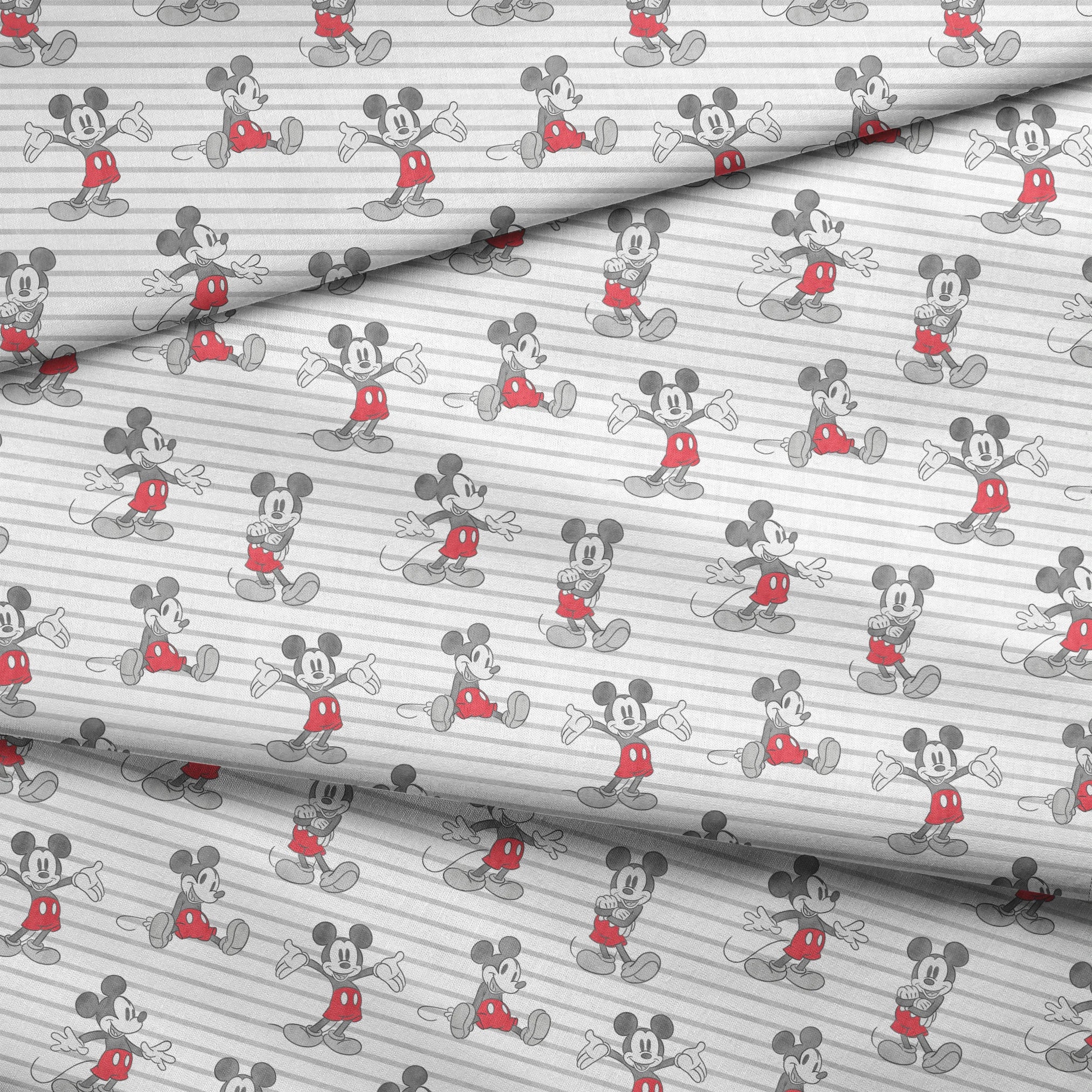 Mickey Mouse cartoon characters in various poses on gray and white striped background fabric fold mockup
