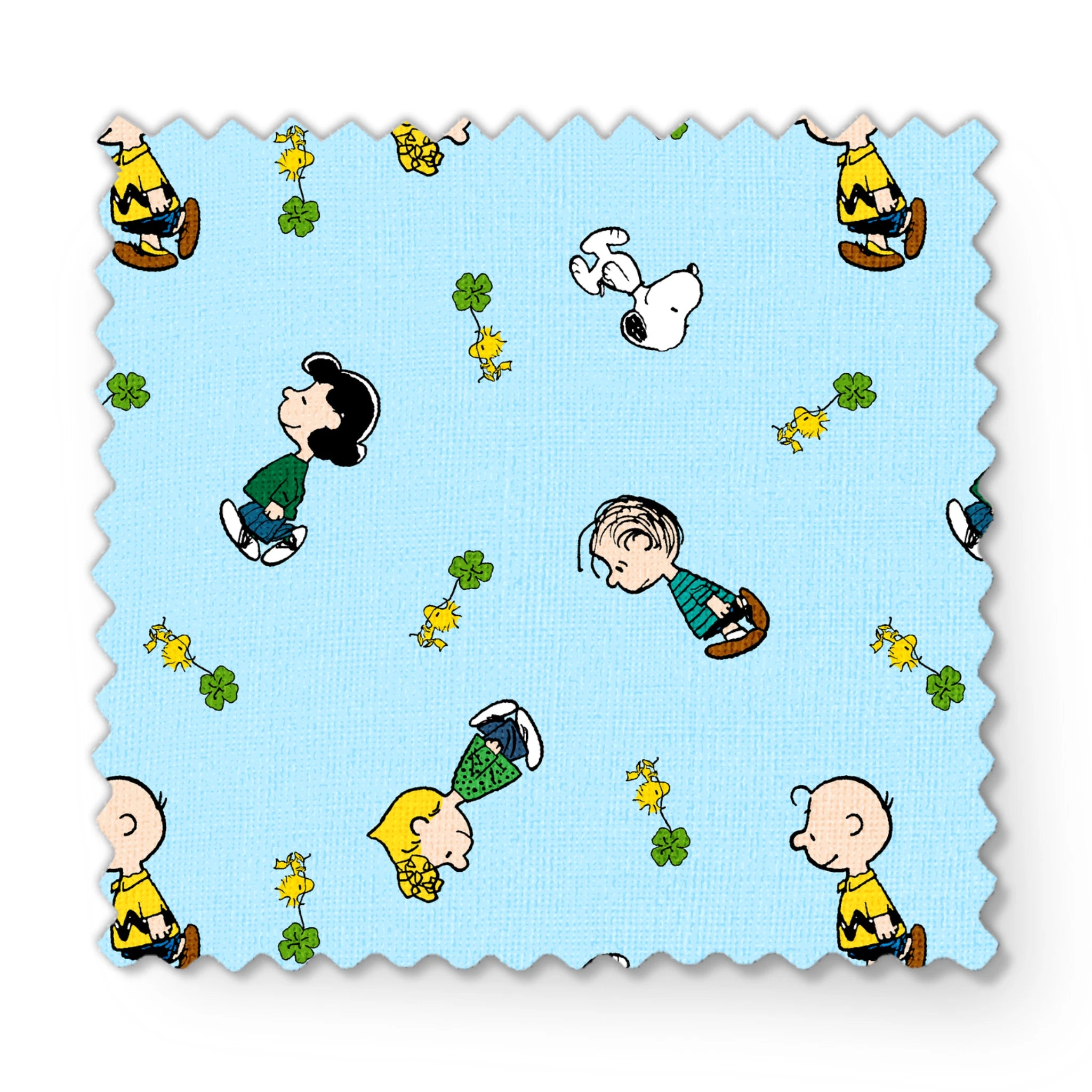 Peanuts cartoon characters on light blue background with clovers fabric swatch mockup