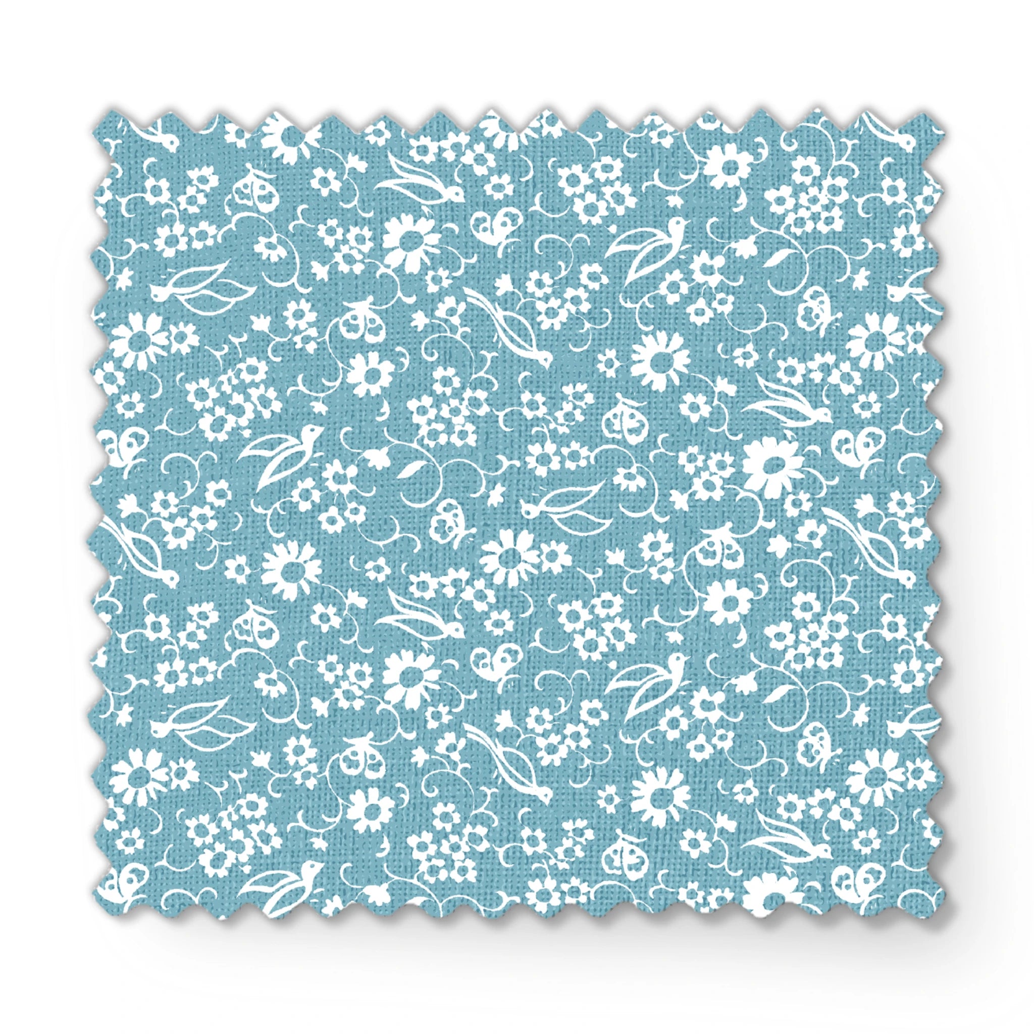 White vintage-style bird and floral silhouettes on a dusty blue background. fabric swatch mockup
