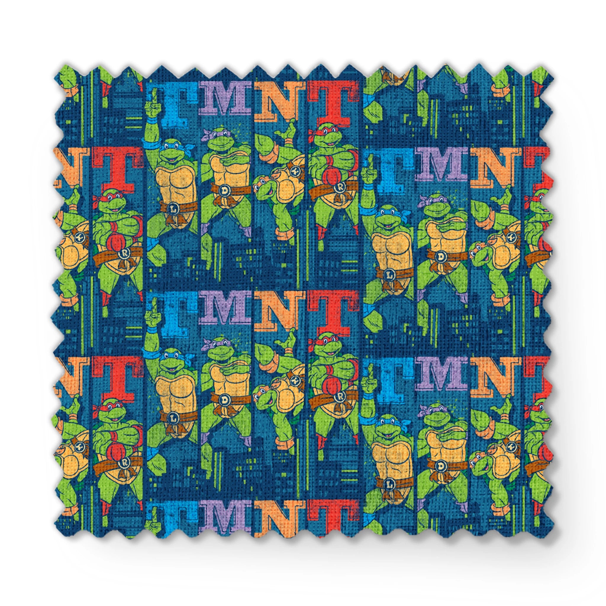 Colorful Teenage Mutant Ninja Turtles cartoon pattern with characters and "TMNT" text on blue cityscape background fabric swatch mockup