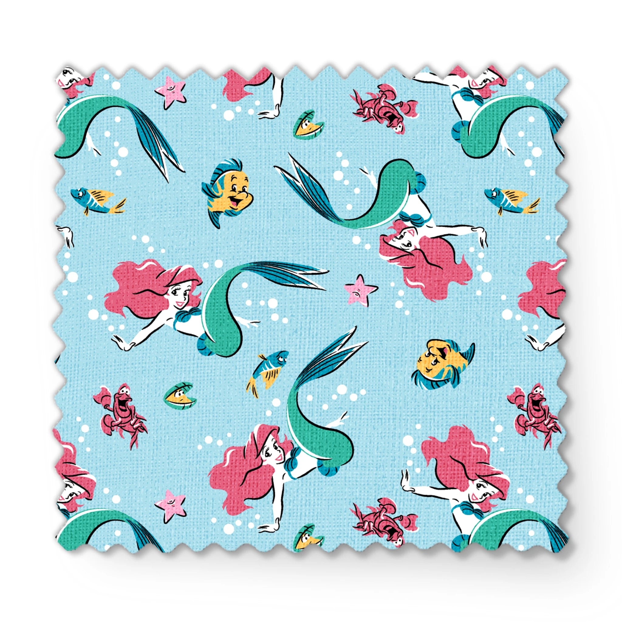 Underwater pattern with colorful mermaids, tropical fish, crabs, and starfish on light blue background fabric swatch mockup