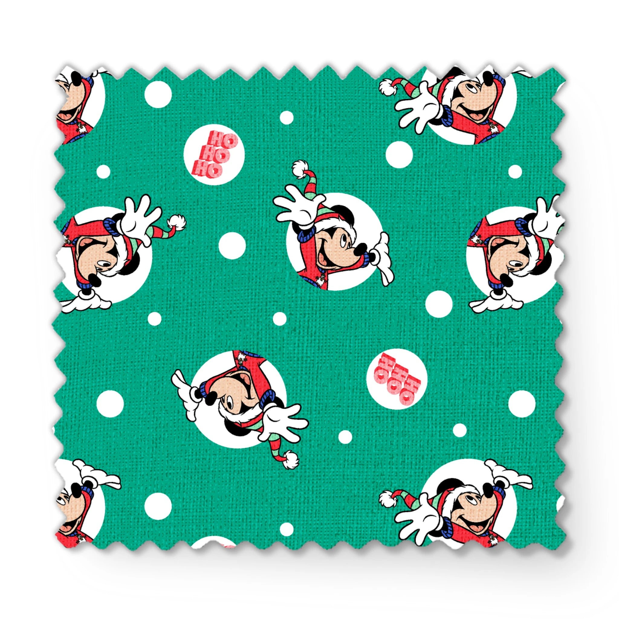 Mickey Mouse in Santa hats on green polka dot background with "Ho Ho Ho" text fabric swatch mockup