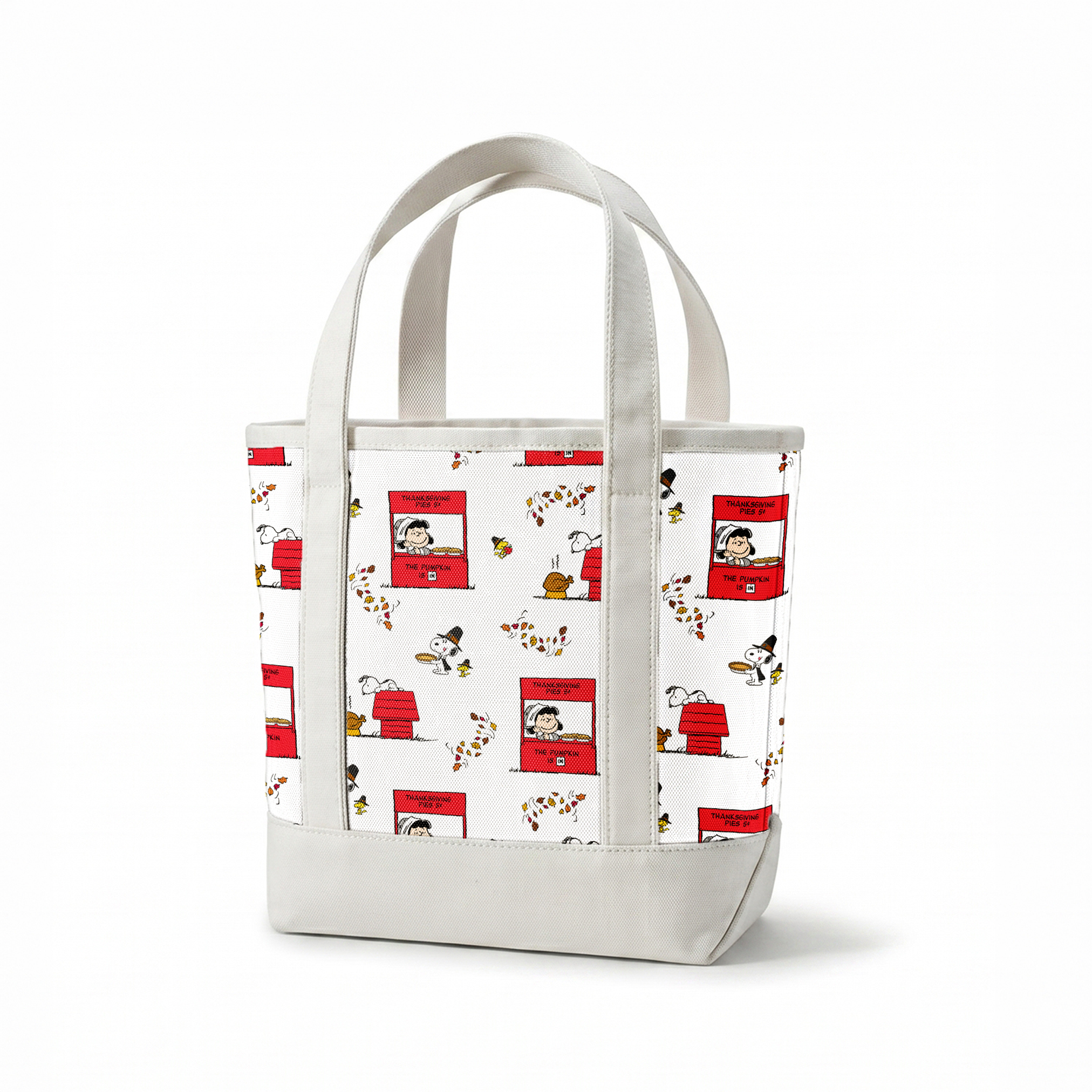 Peanuts Thanksgiving pattern with Snoopy, red booths, doghouses, and falling autumn leaves on white background springs canvastote mockup