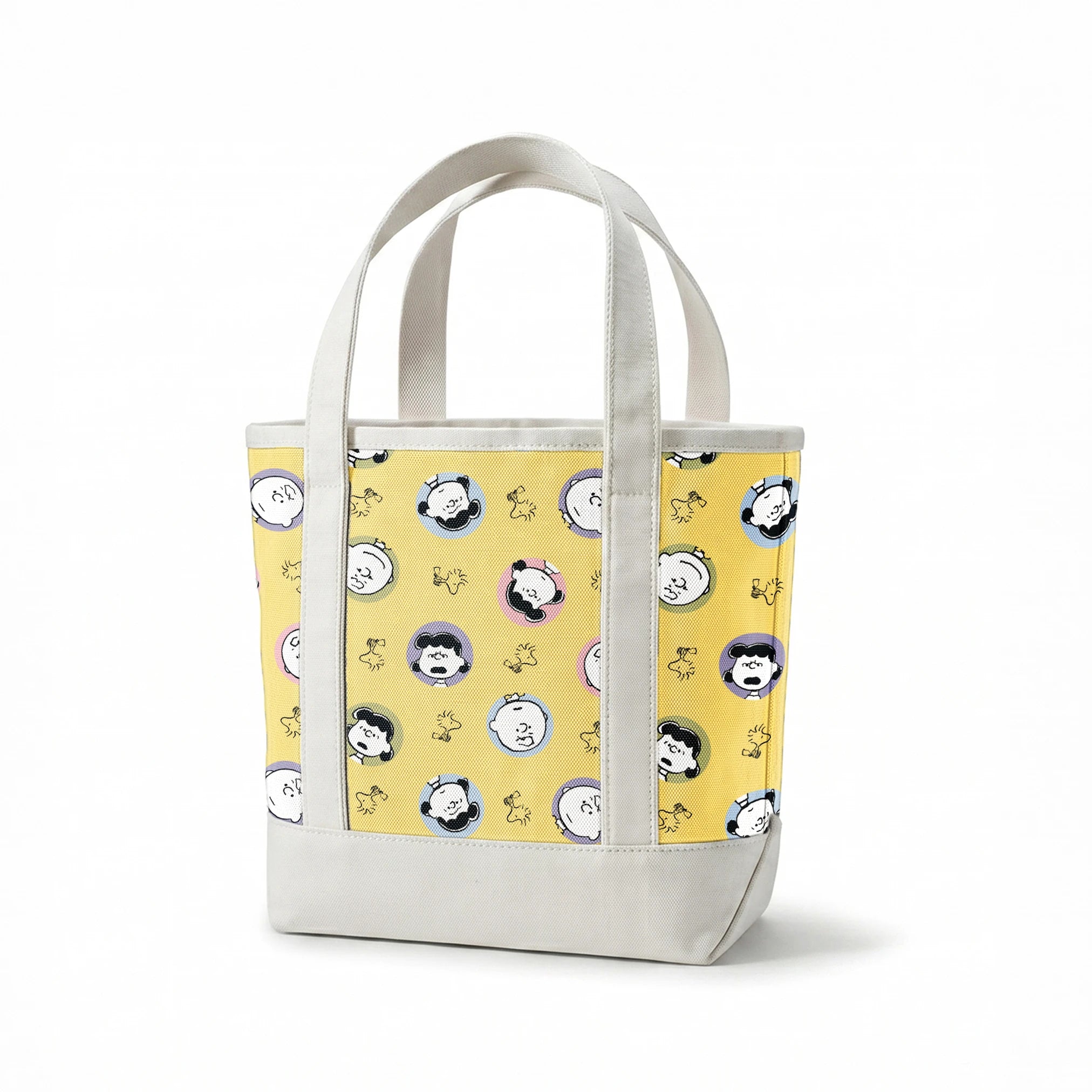Peanuts characters pattern with Charlie Brown and friends in circular frames on yellow background with Woodstock silhouettes springs canvastote mockup