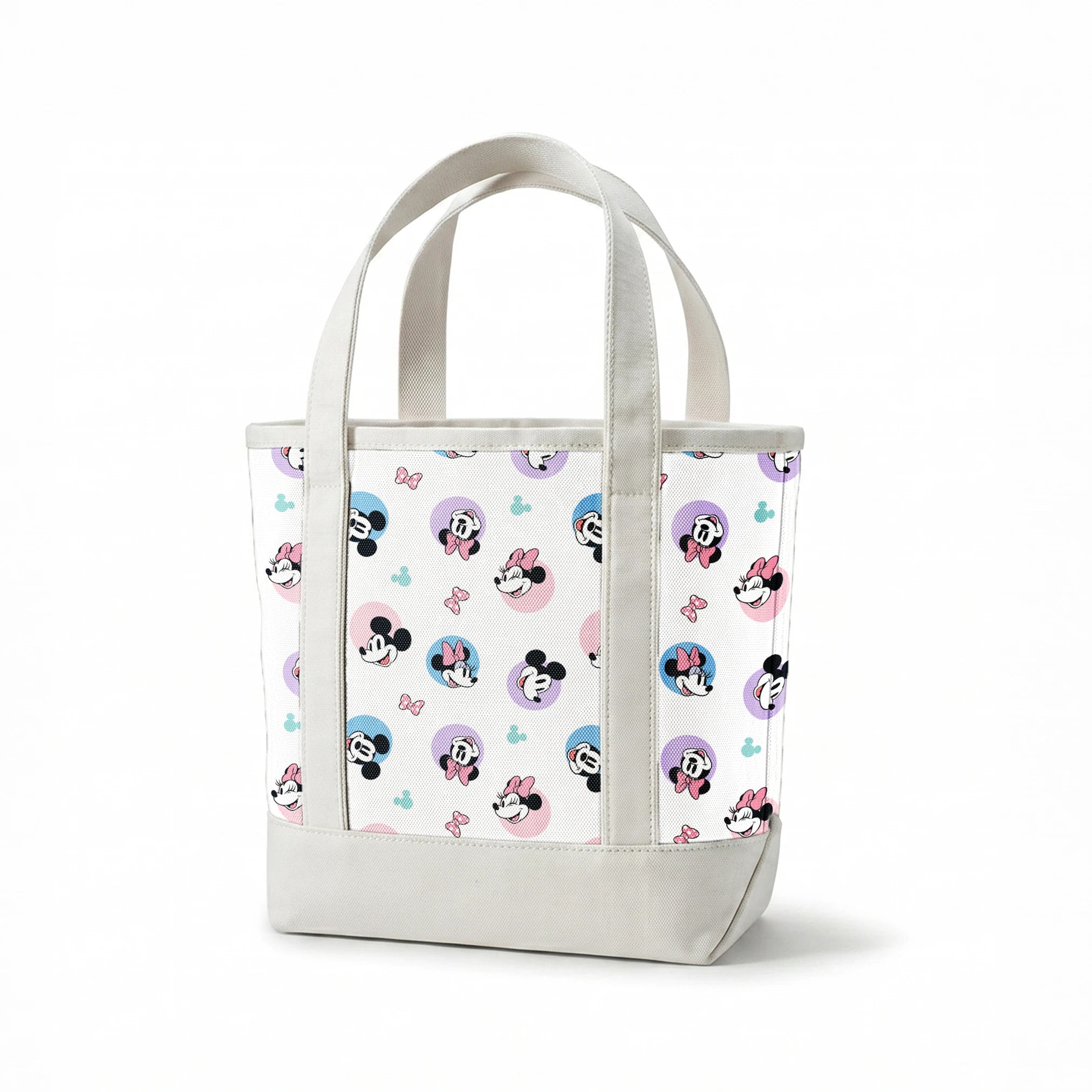 Disney Mickey and Minnie Mouse pattern with character heads on pastel circles, pink bows, and small Mickey icons springs canvastote mockup