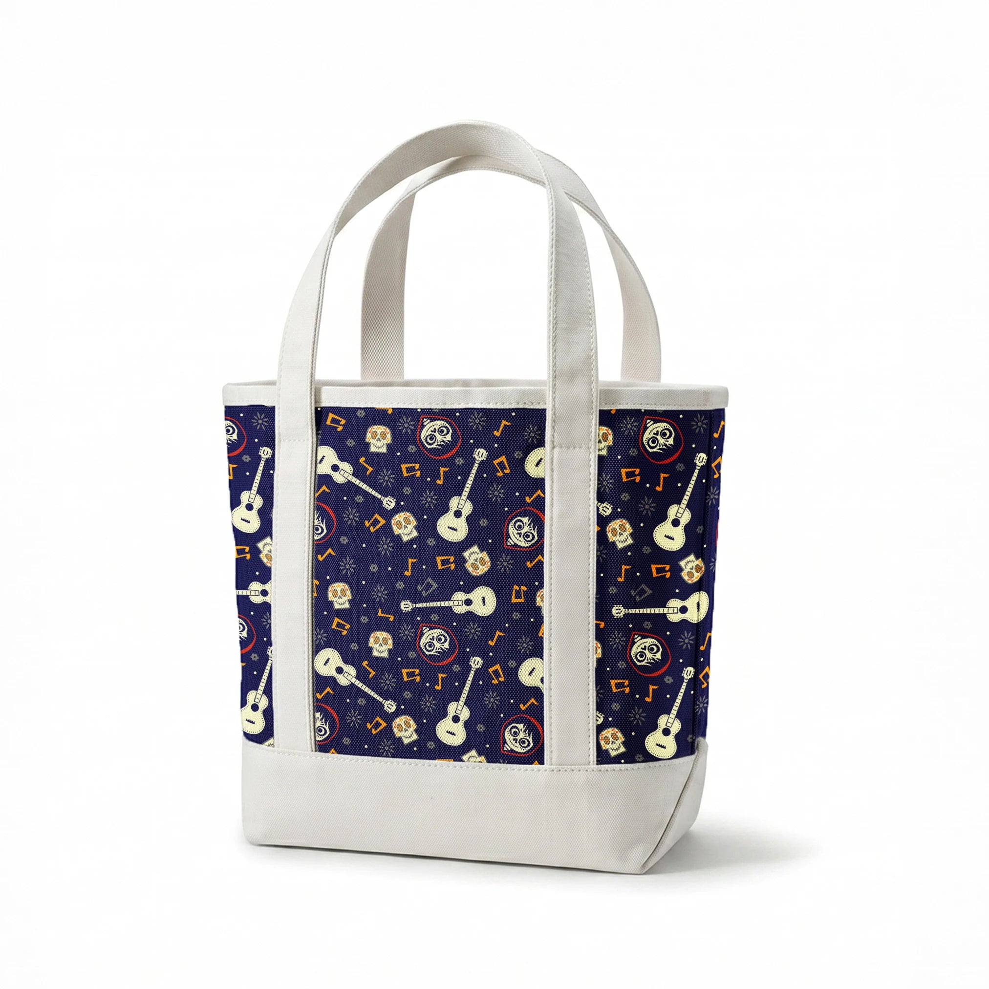 Coco dark blue pattern with white acoustic guitars, decorative skulls, orange musical notes, and circular designs scattered across a starry background. springs canvastote mockup