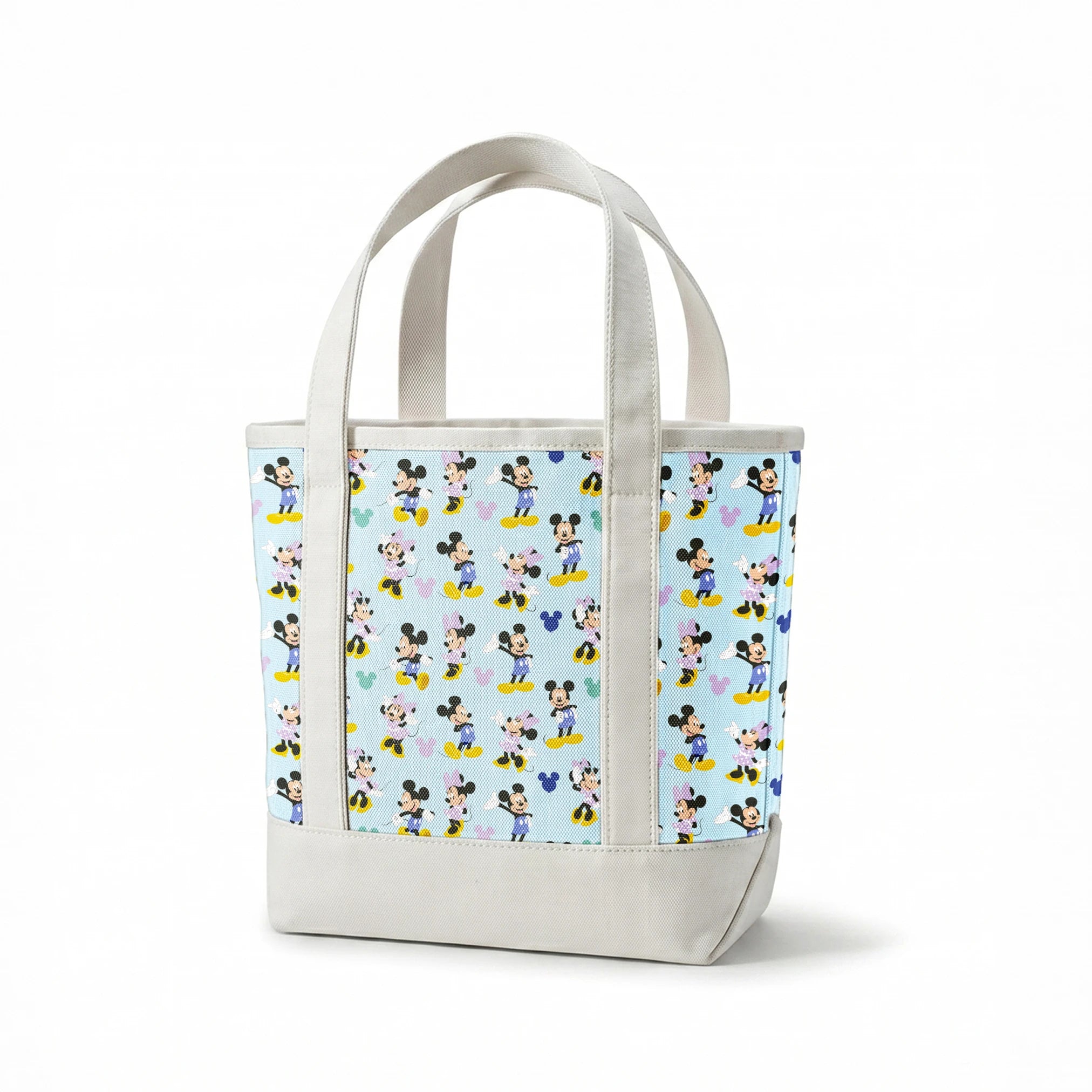Pattern of Mickey and Minnie Mouse characters in various poses on light blue background springs canvastote mockup