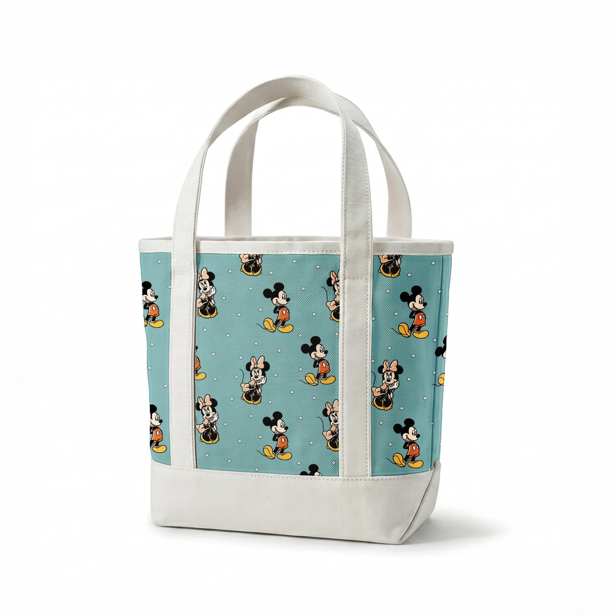 Cartoon pattern of Mickey and Minnie Mouse characters on light blue background with white dots springs canvastote mockup