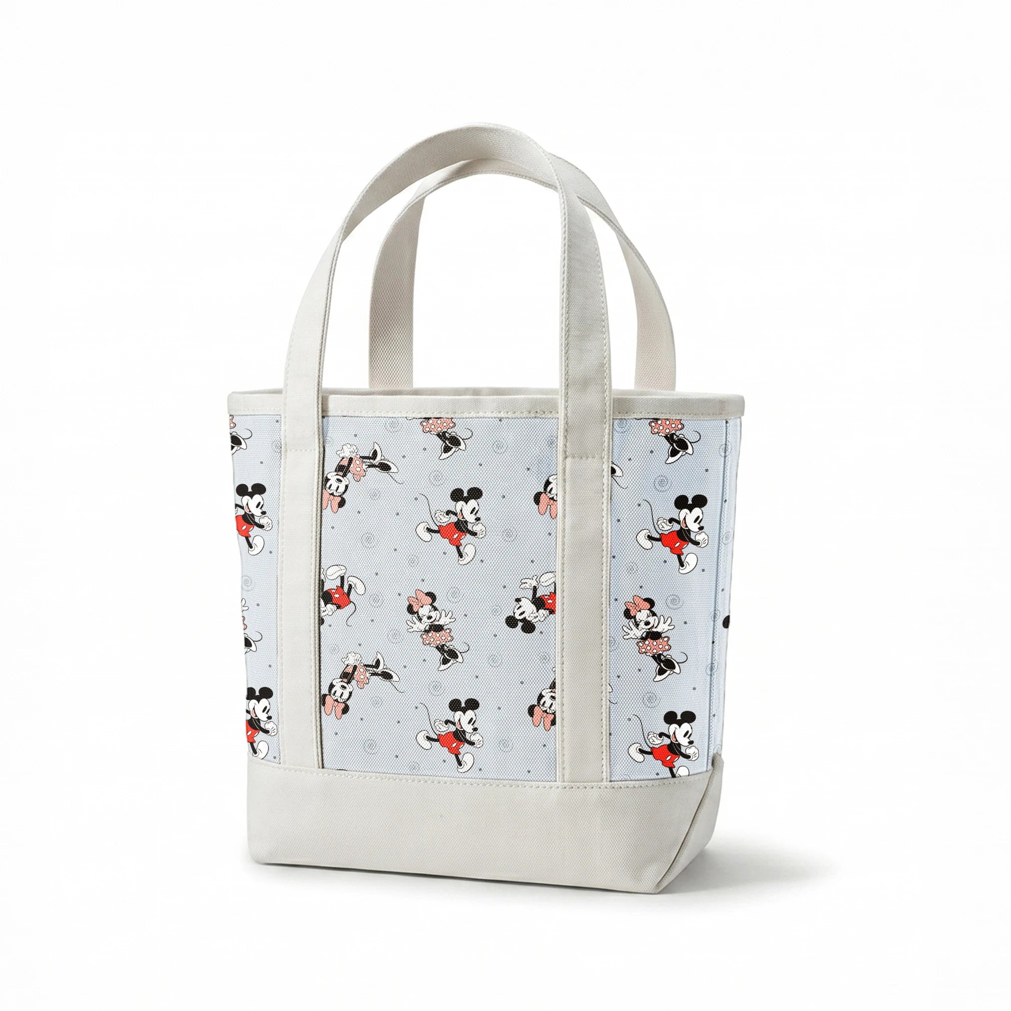 Classic Minnie and Mickey Mouse pattern with characters in various poses on light blue background with swirls springs canvastote mockup