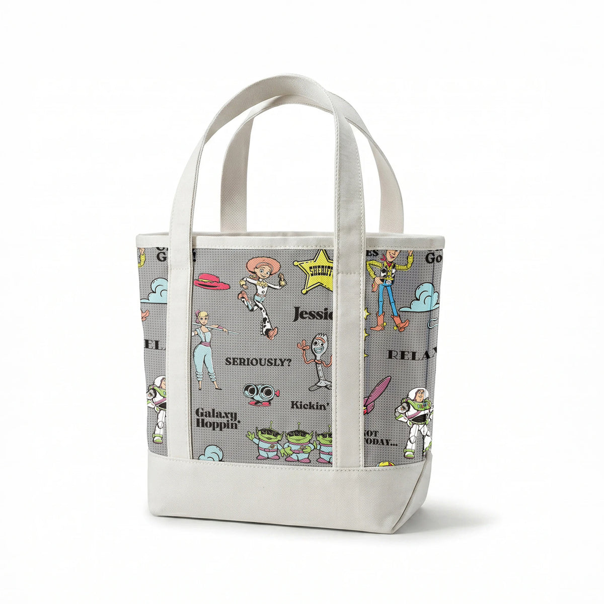 Toy Story character pattern with Buzz, Woody and aliens on gray background with phrases like "Good Vibes" and "Galaxy Hoppin' springs canvastote mockup