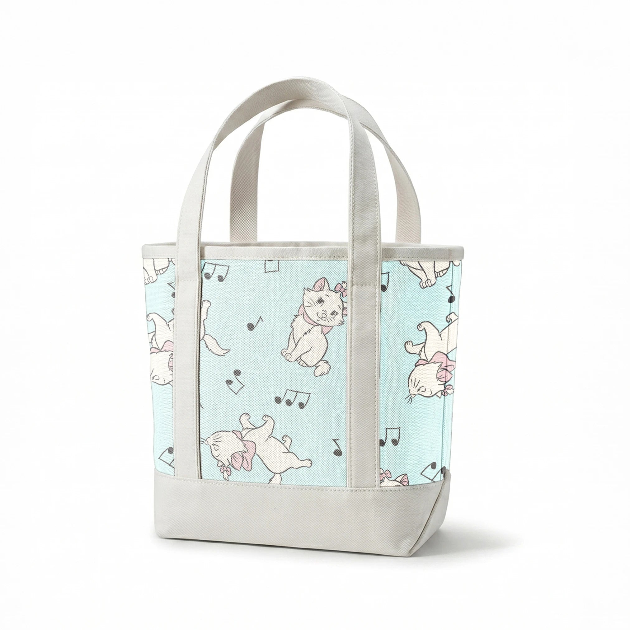 White kittens with pink bows playing among musical notes on a light mint background springs canvastote mockup