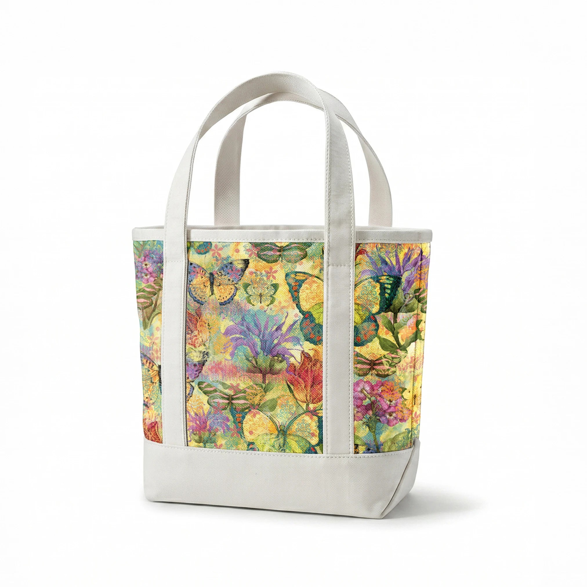 Colorful pattern of butterflies and flowers in vibrant yellows, purples, and reds with watercolor texture springs canvastote mockup