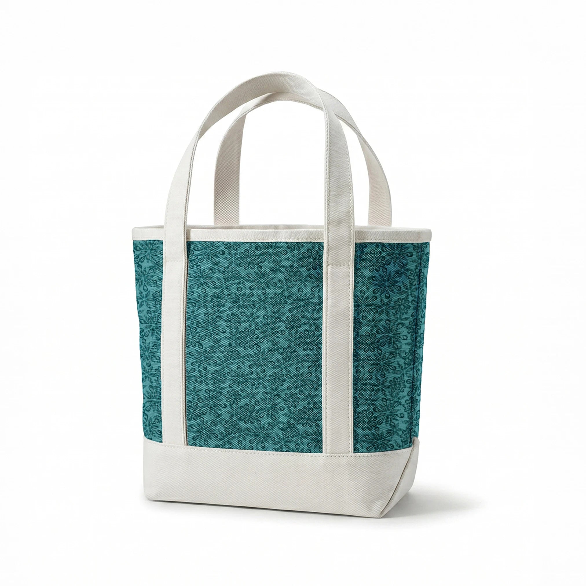 Outlined floral pattern in dark teal on a lighter teal background by Nicole Tamarin. springs canvastote mockup