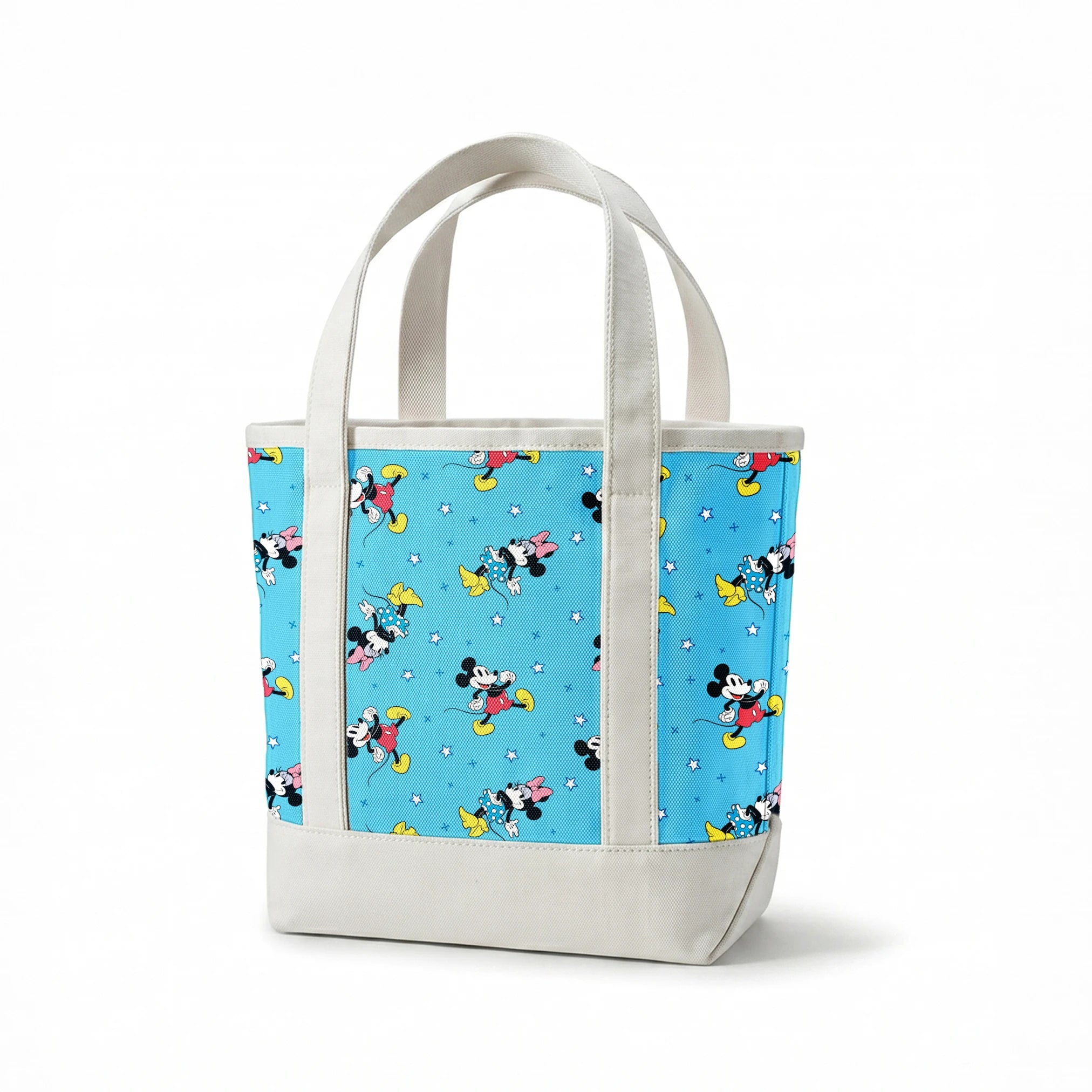 Disney Mickey Mouse and Minnie Mouse characters on light blue background with white stars, pattern design springs canvastote mockup