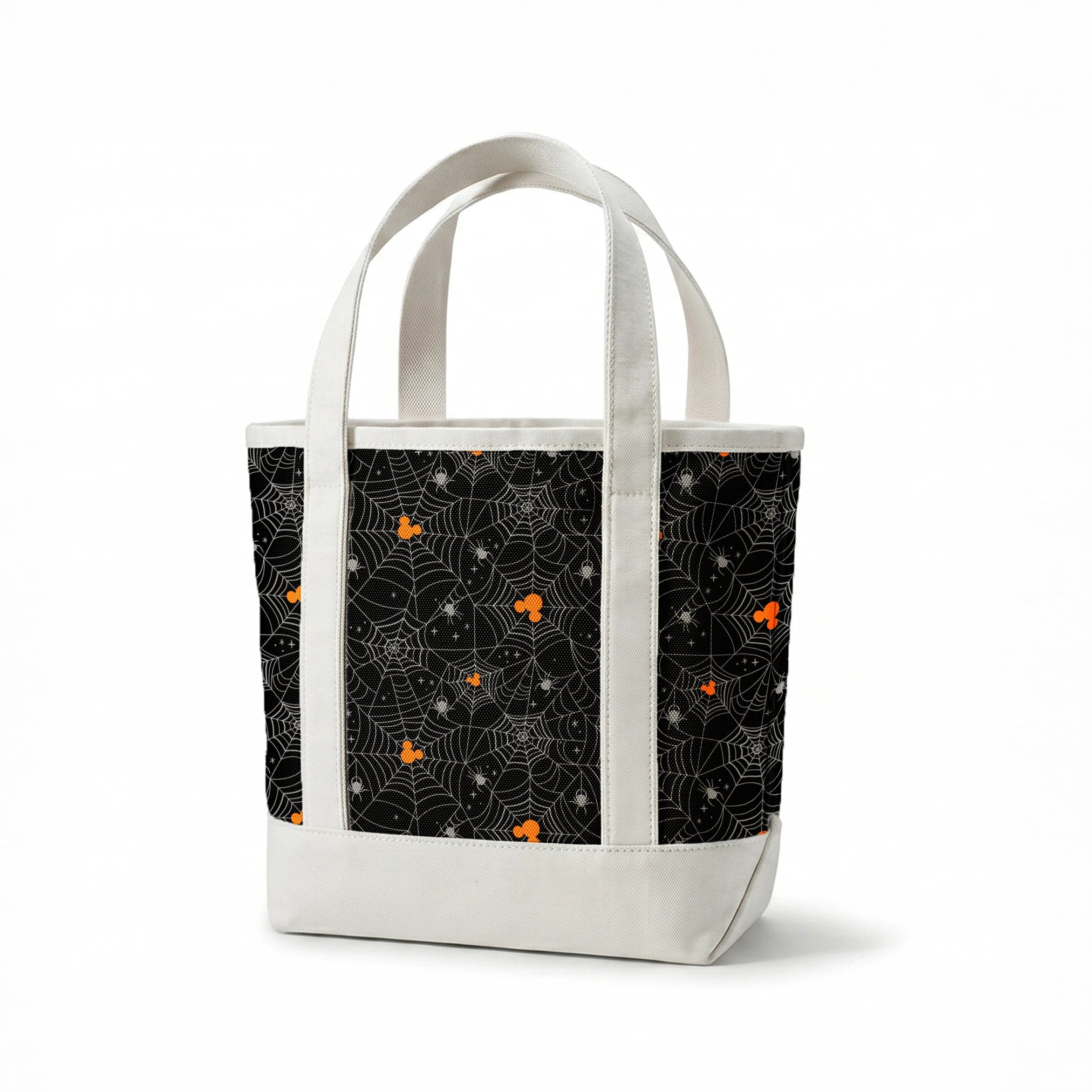 Spooky Halloween pattern with white spiderwebs, orange Mickey Mouse heads, and gray spiders on black background springs canvastote mockup