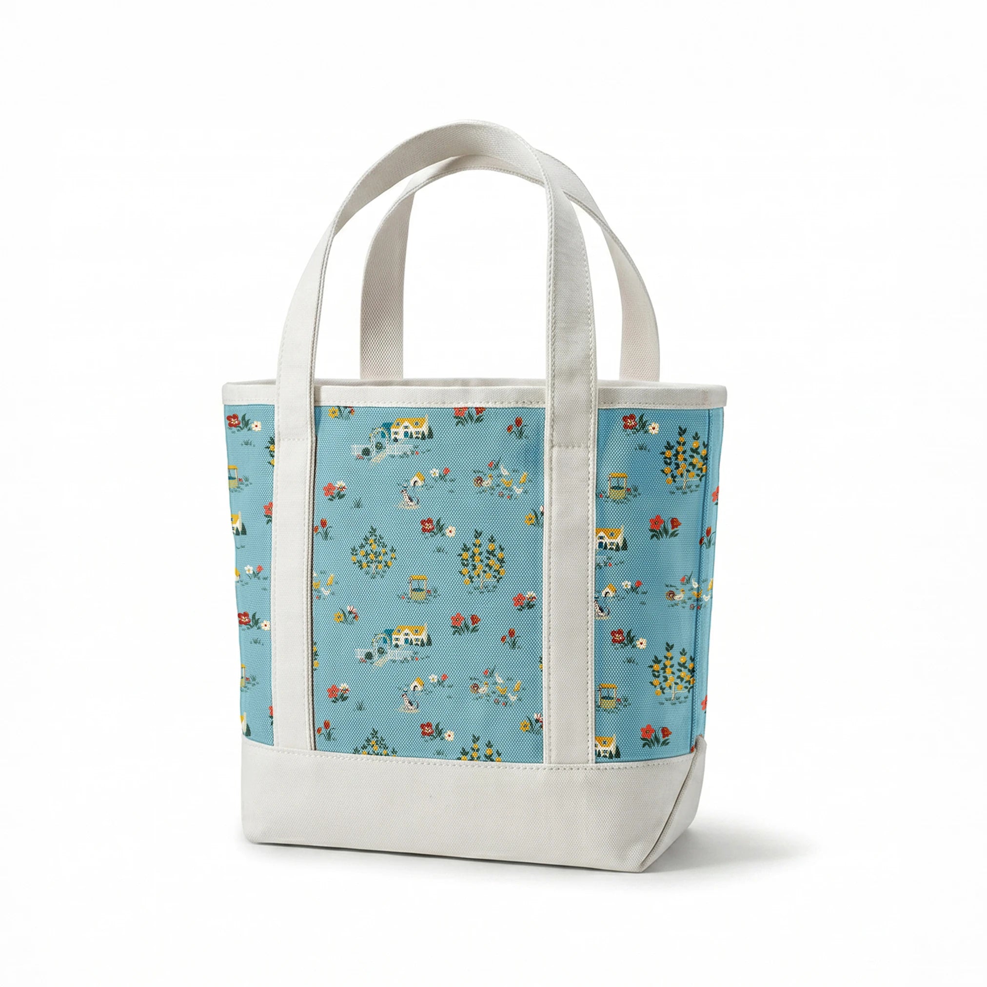 Blue-gray background with repeating folk art pattern of small cottages, white geese, floral clusters, and colorful tulips in yellow and red. springs canvastote mockup
