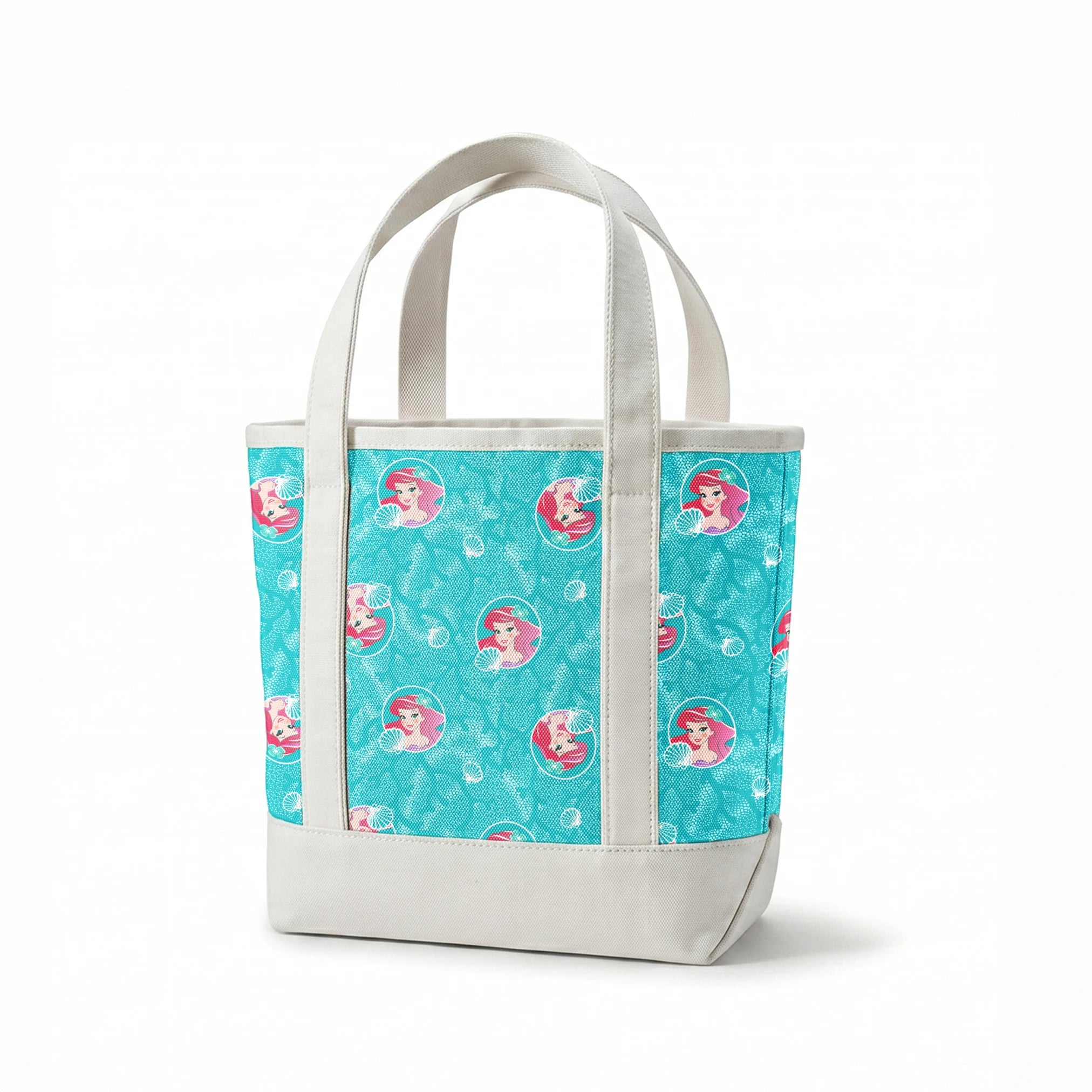 The Little Mermaid pattern with Ariel in turquoise circles on aqua background with seashells springs canvastote mockup