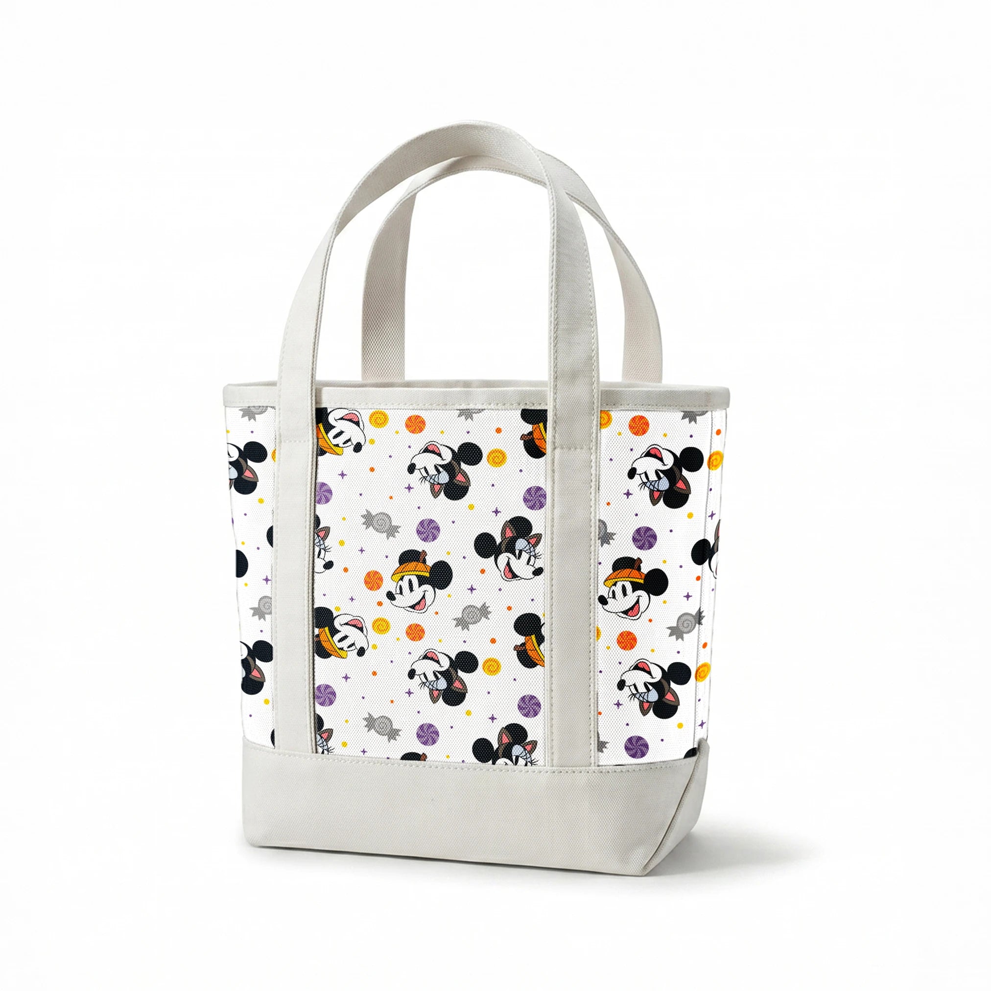 Mickey and Minnie Mouse cartoon heads scattered with wrapped candies and colorful dots on white background springs canvastote mockup