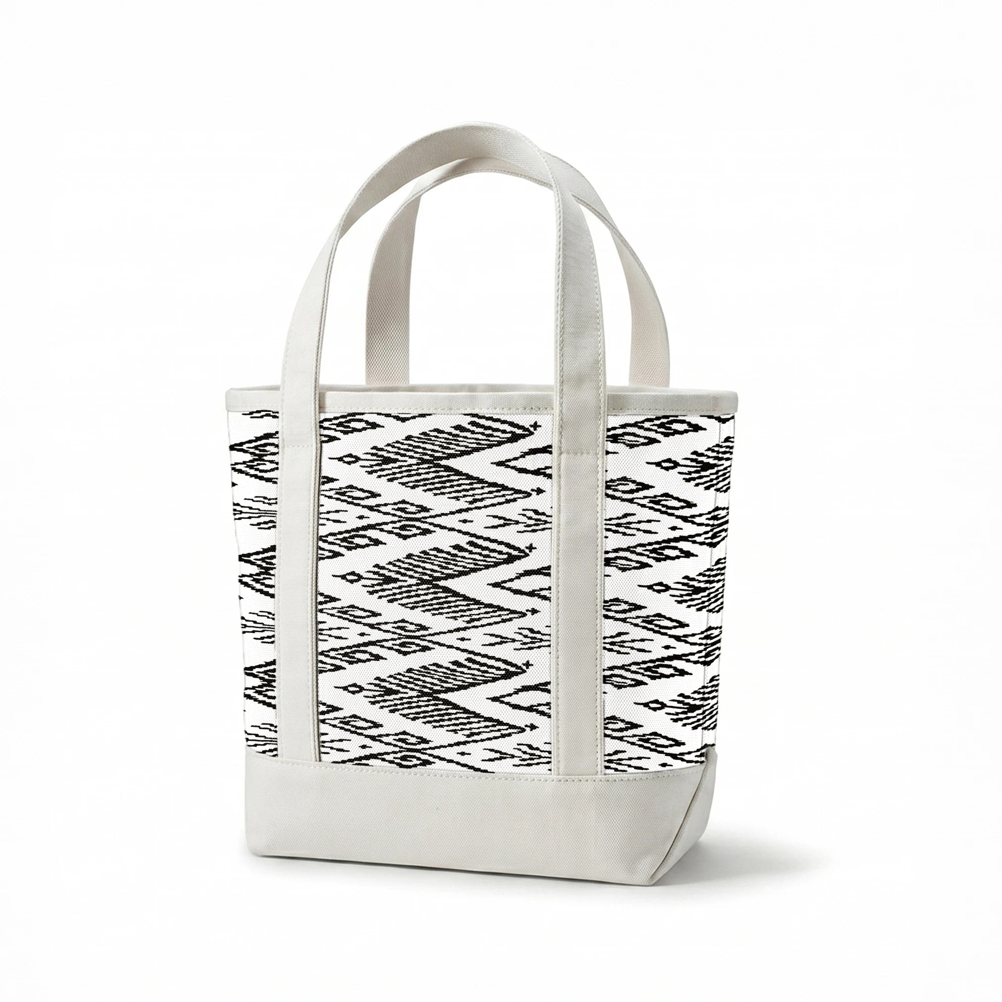 Black and white geometric pattern with diamond shapes and zigzag motifs on a textile surface springs canvastote mockup