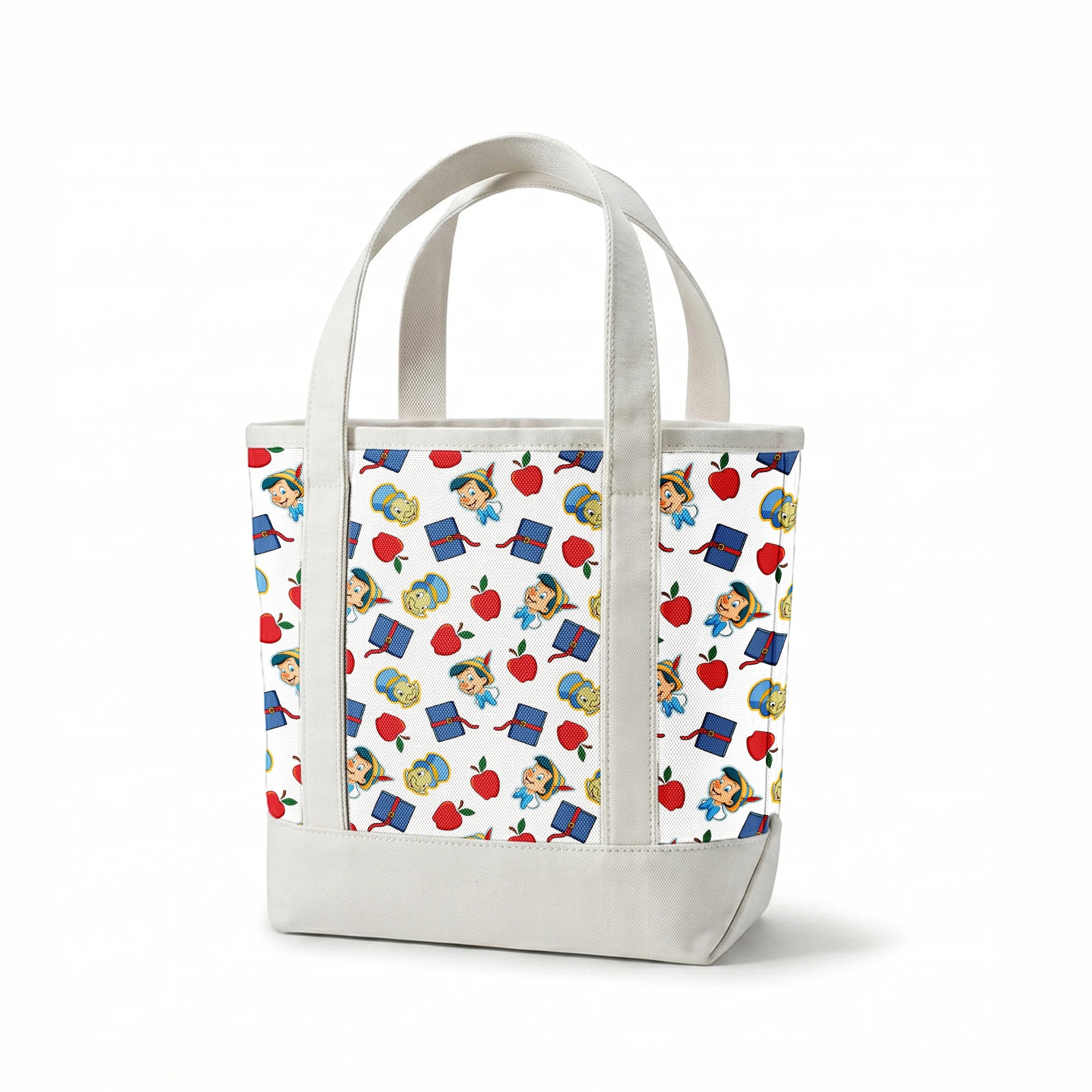 Pattern with cartoon character in pointed hat with blue bow, red apples, blue books with red straps, and yellow circular elements on white background springs canvastote mockup